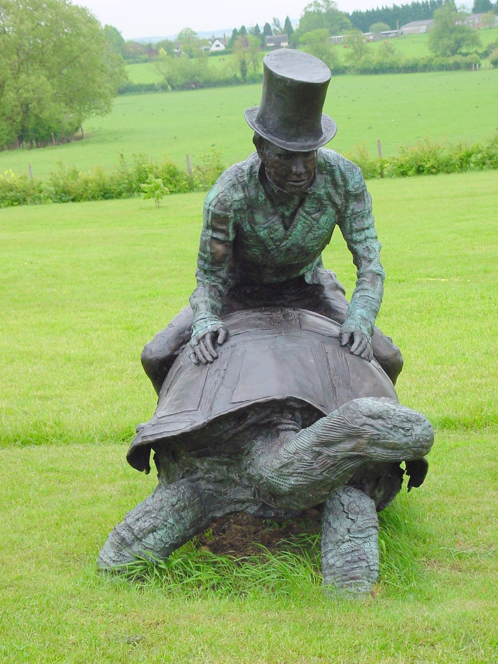 Charles Darwin astride Giant Tortoise