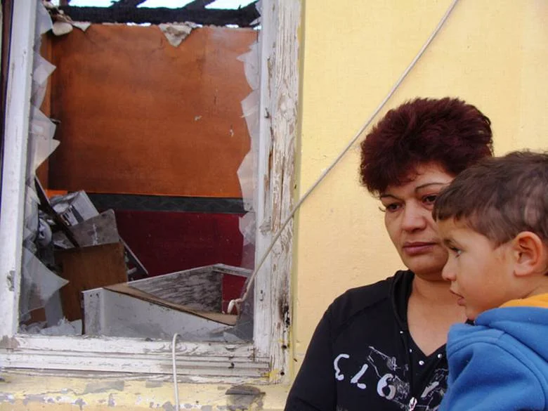 2010: Csabane Csorba and her three-year-old grandson, Mate, examine the ruins of their house in the Hungarian Roma village of Tatarszentgyorgy. Her son Robert, 27, Mate’s father, and his other son Robert Jr., 5, were killed in a firebomb and gunfire attack by a far-right militia. Similar attacks over the years have sent a flood of Roma refugees to Canada to seek asylum from growing extremism. DOUG SAUNDERS/THE GLOBE AND MAIL