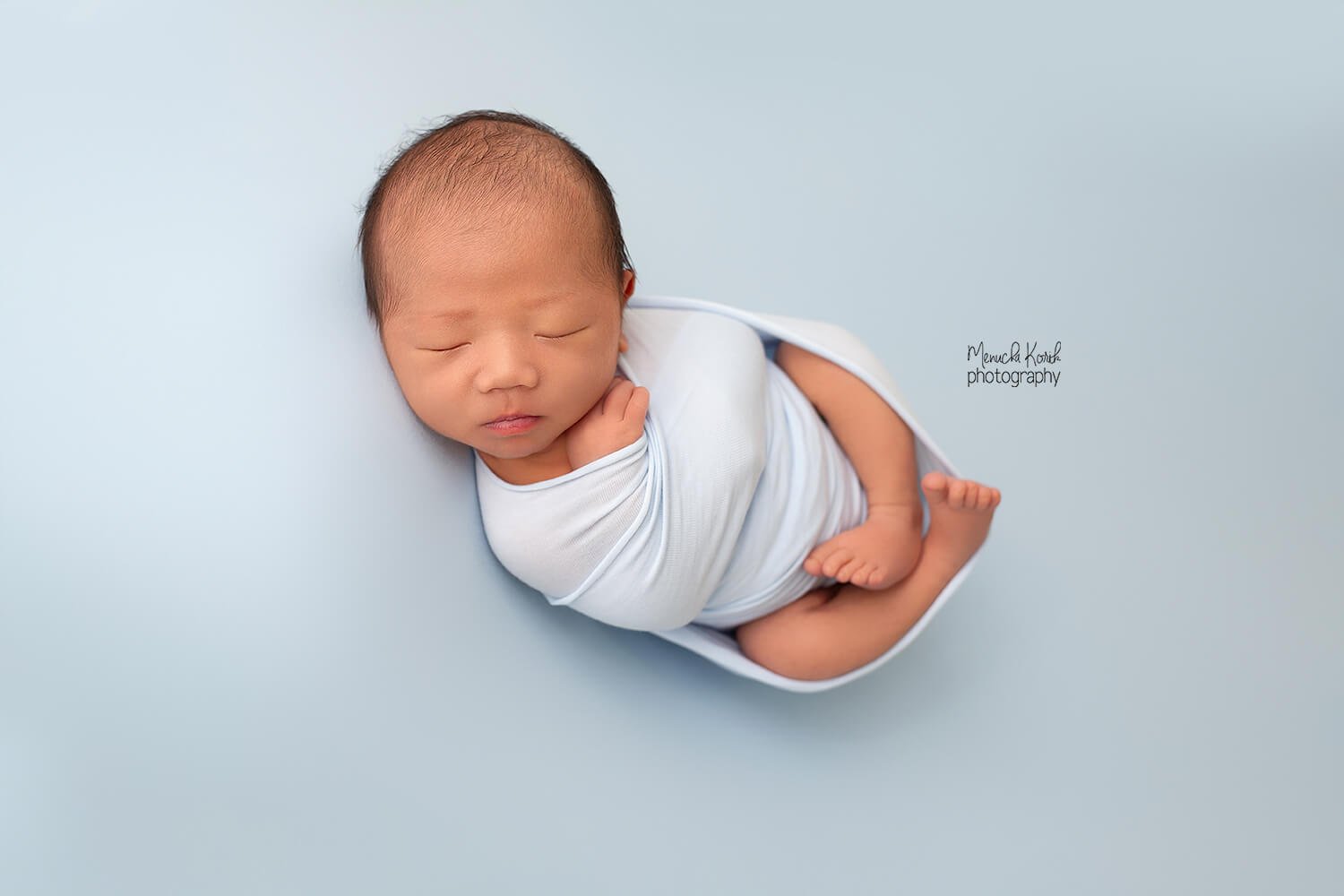 Newborn baby boy wrapped in baby blue during a Newborn session in Melbourne