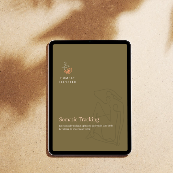 A tablet displaying a digital app titled 'Somatic Tracking' by 'Humbly Elevated' on a sandy surface.