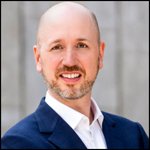 Smiling white gentleman with folded arms