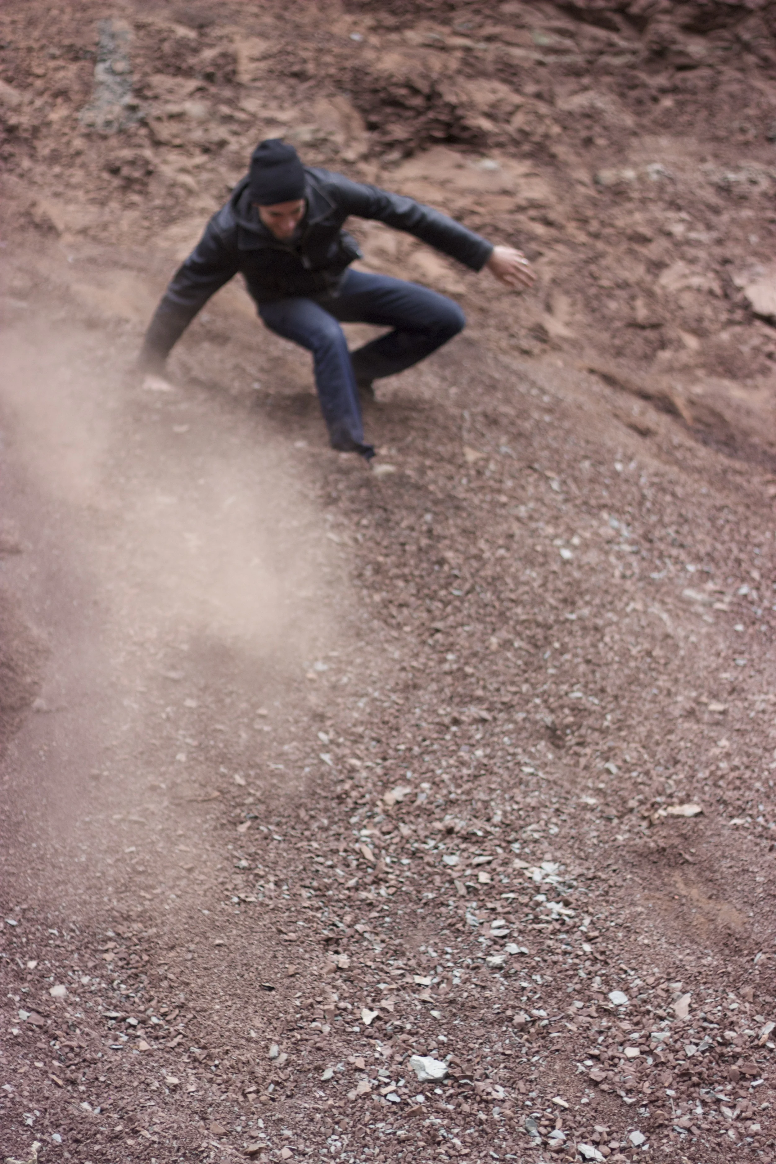sim sliding down some red rock