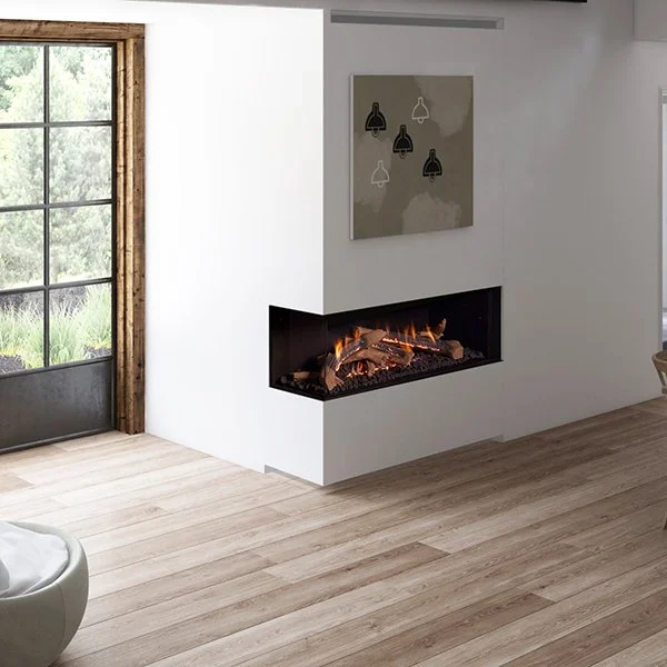 Modern living room with a white wall, a rectangular fireplace with flames, an abstract wall art piece, and a large window showing green outdoor scenery.