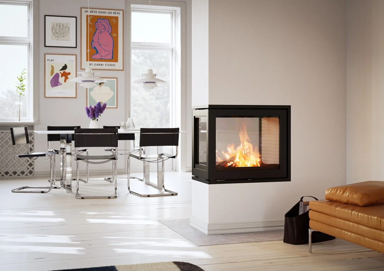 Modern living room with a fireplace, tan sofa, and a dining area with a black table and chairs, decorated with wall art and a vase with purple flowers.