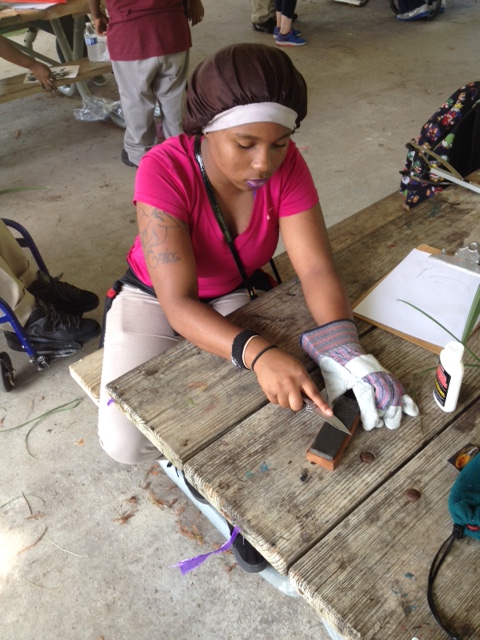 A Sci Academy scholar learns about knife safety and sharpening as we prepare an afternoon snack!
