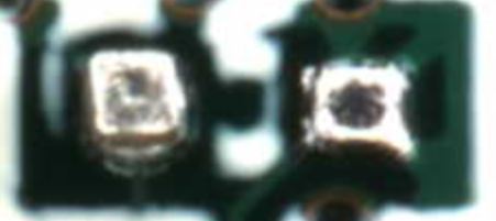 This is what a "Tombstone" defect looks like. It might be hard to notice at first, but the pad on the left has the 0402 capacitor standing straight up in the air.
