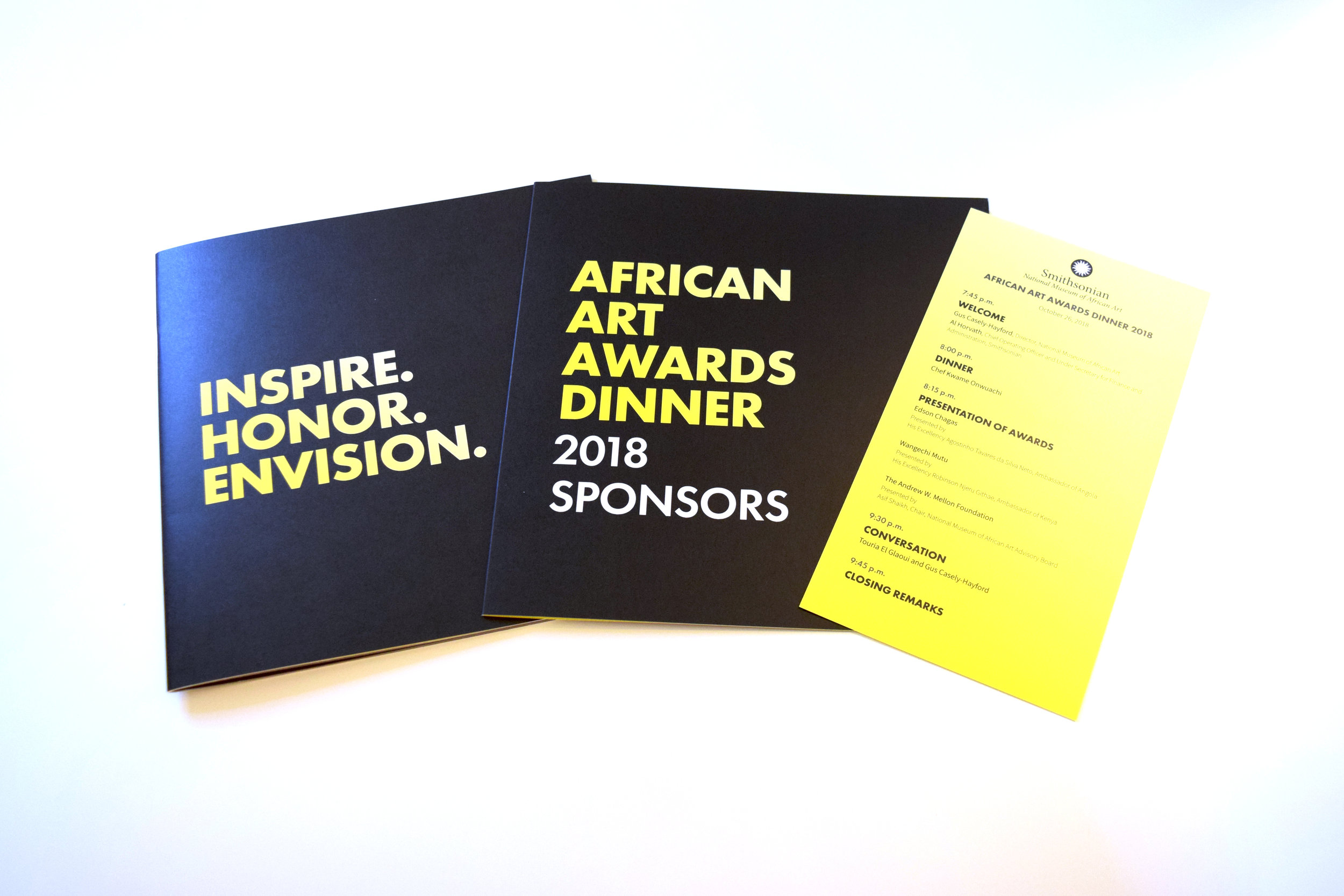 A printed program, sponsors book, and event menu for the African Art Awards Dinner. Printed in black and yellow.