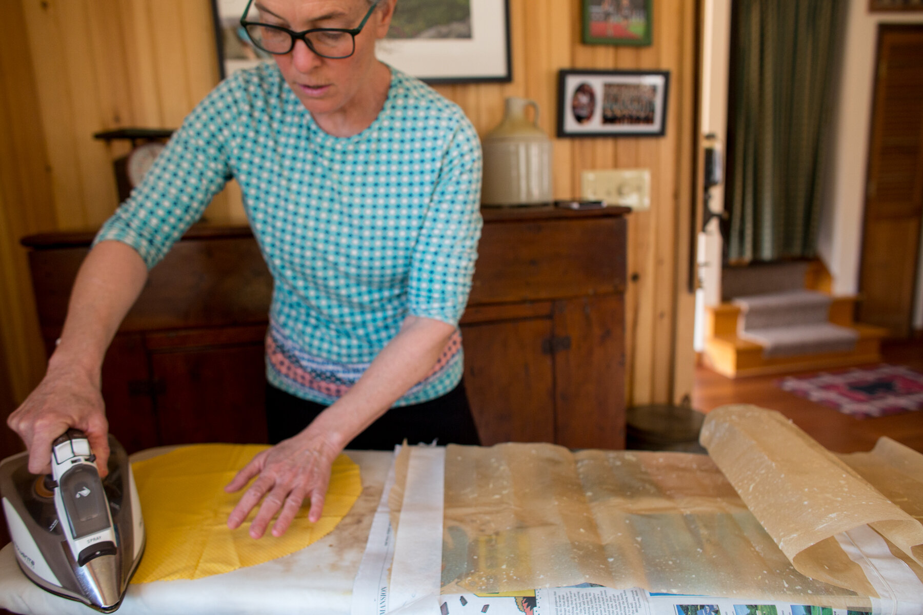 Cover your ironing board with a double layer of parchment paper.