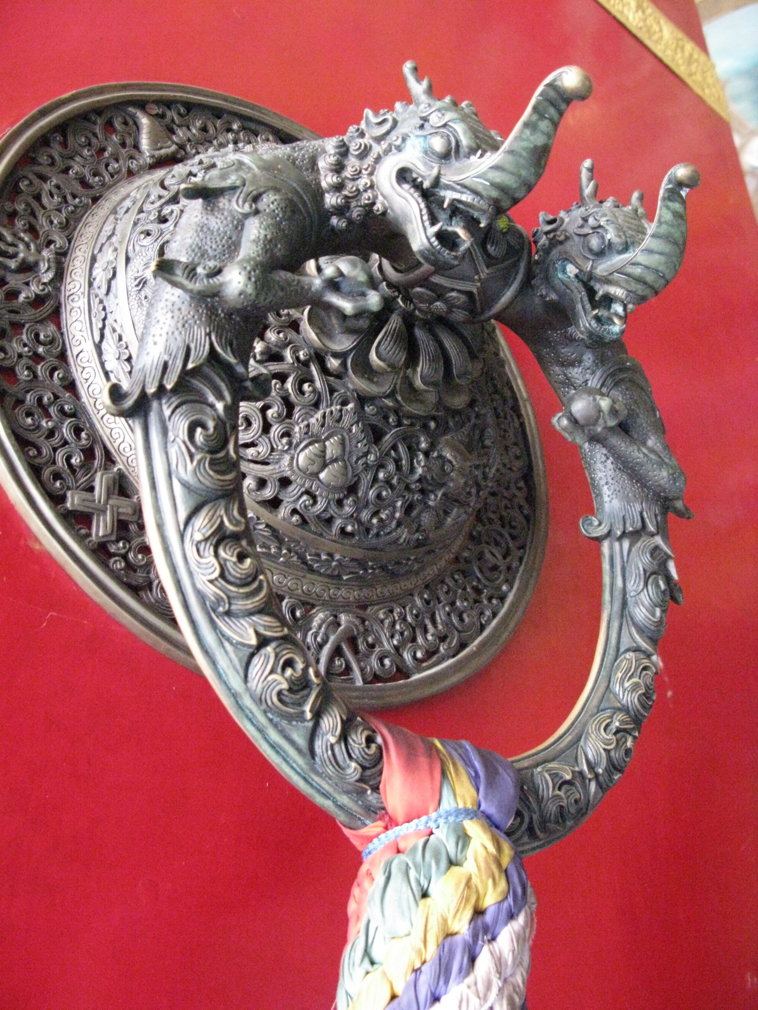 Temple door ring, Maha Bodhi Temple, Bodh Gaya, India. This looks like lost wax cast metal that has been "chased"to correct any casting defects and sharpen up any loss of form. An amazing realization of craft and artistic imagination.