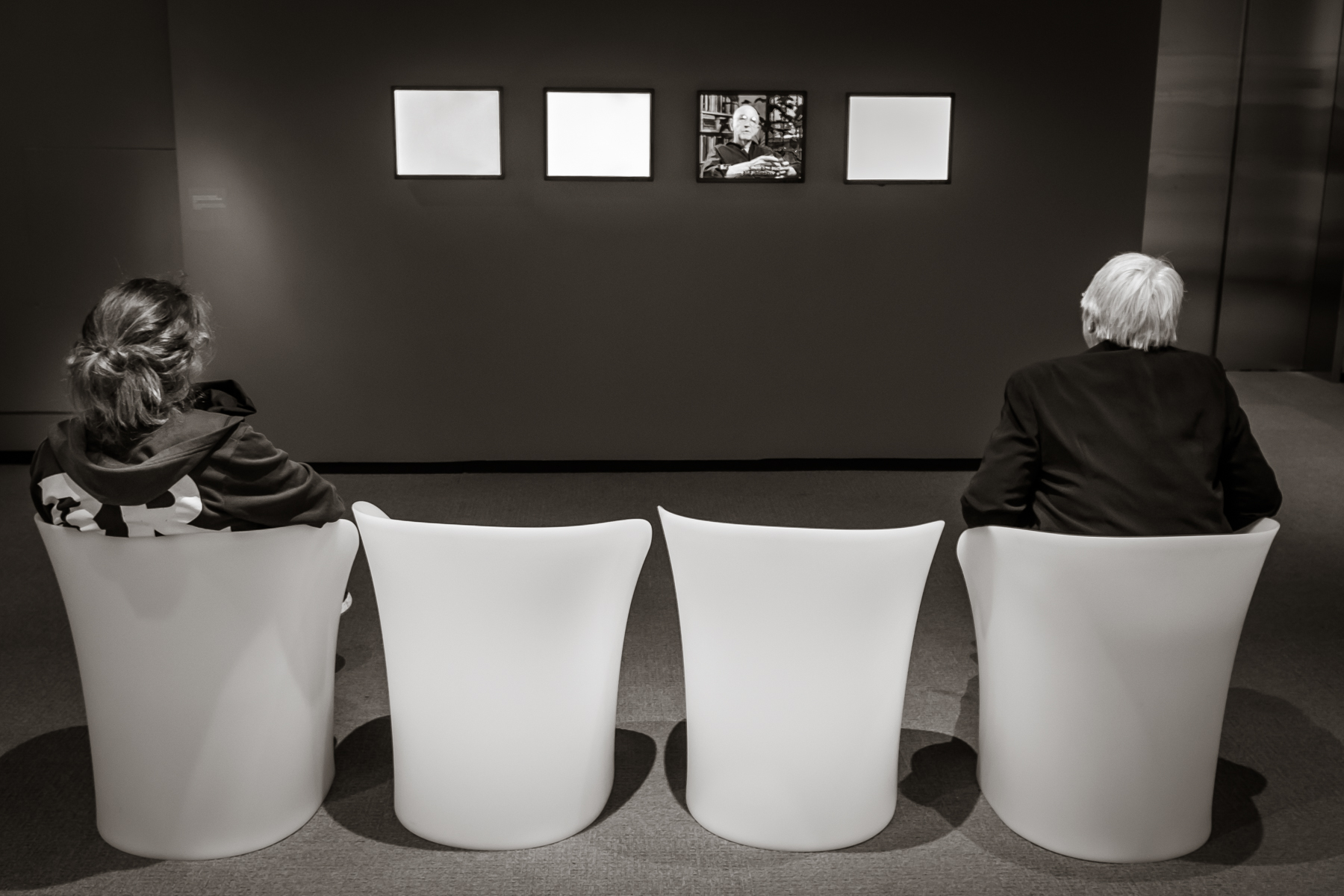 Visitors to Duane Michals' retrospective at the Peabody Essex Museum in Salem, MA listening to him address the Big Questions
