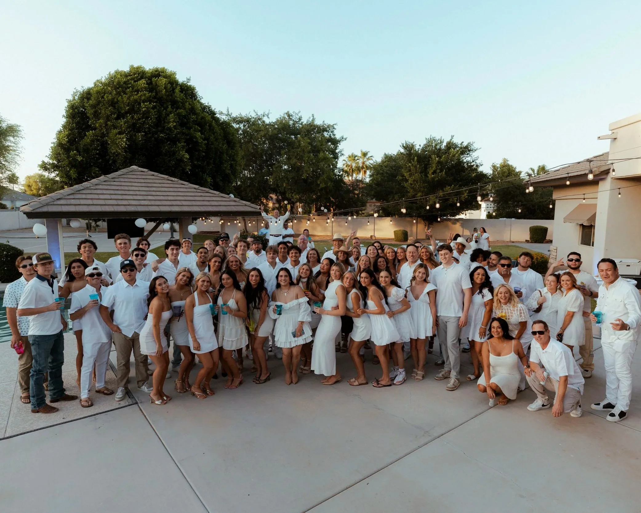 Group of high school seniors enjoying a backyard graduation party