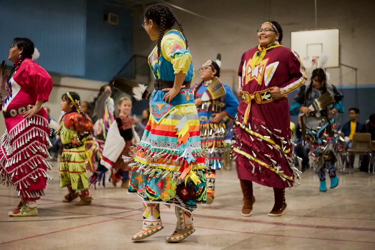 Torri, center, is wearing her traditional regalia during Native Heritage week.