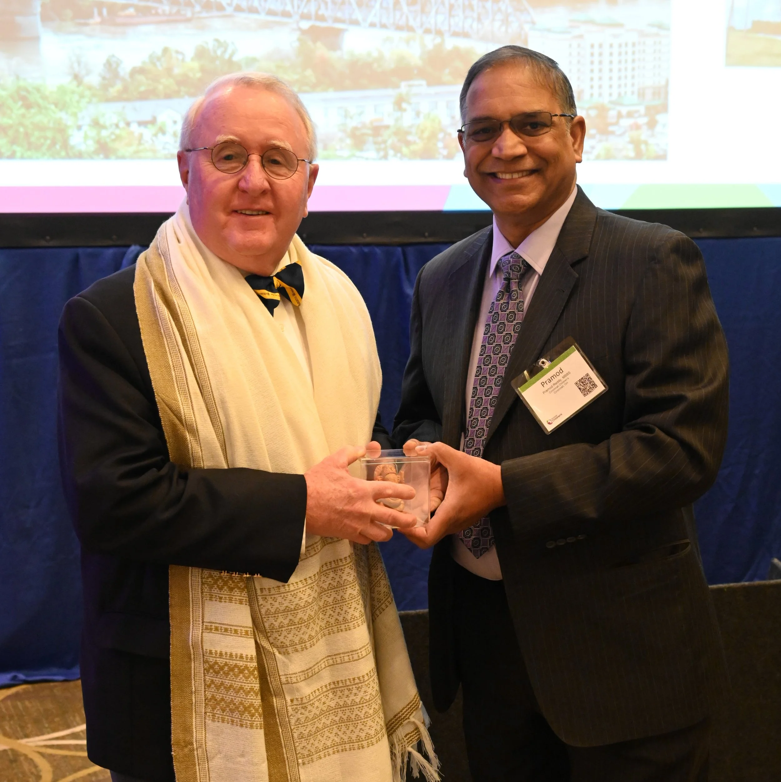 Dr. Cromie receiving a gift from Dr. Reddy.