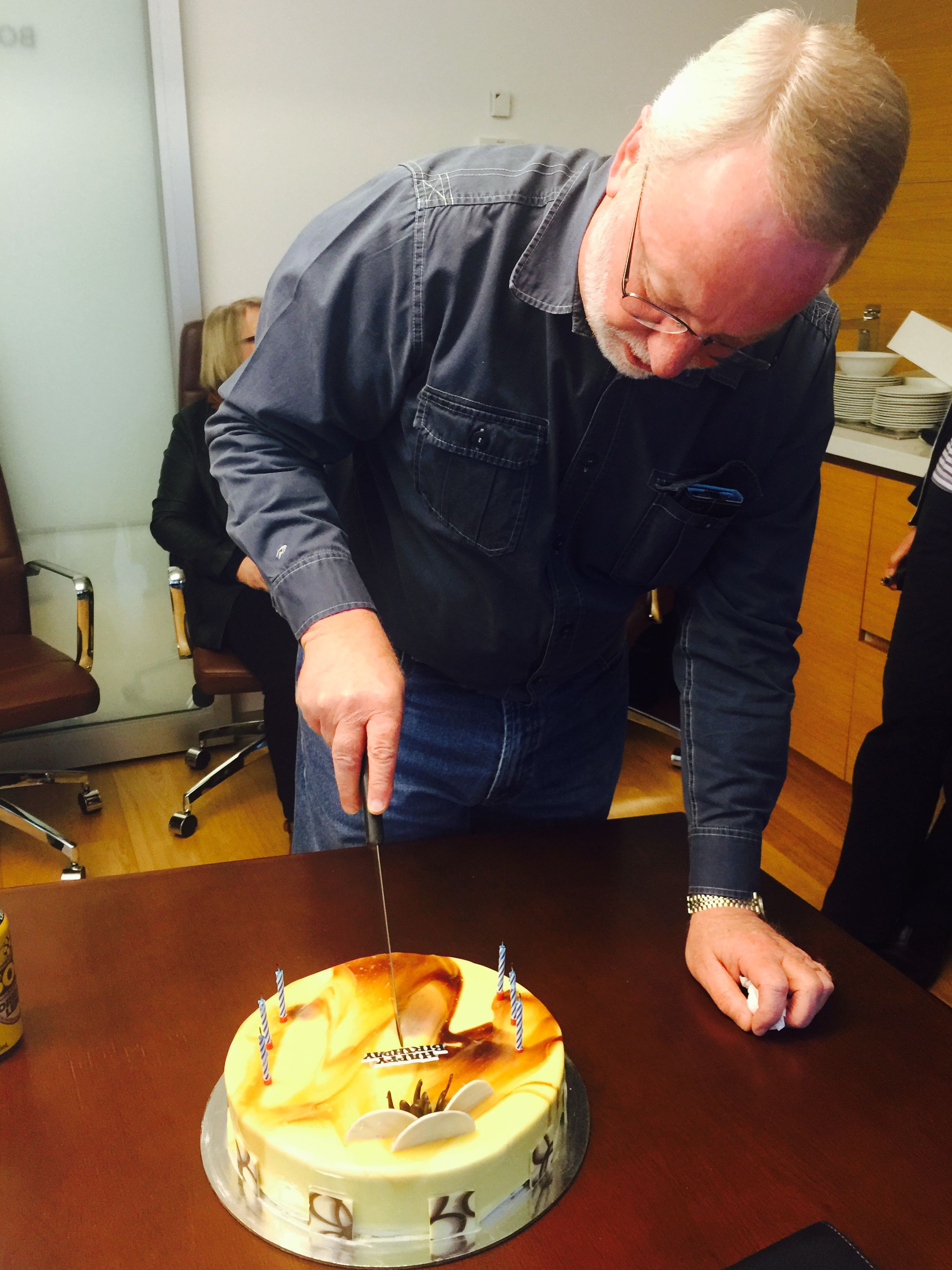 Proudly cutting his birthday cake