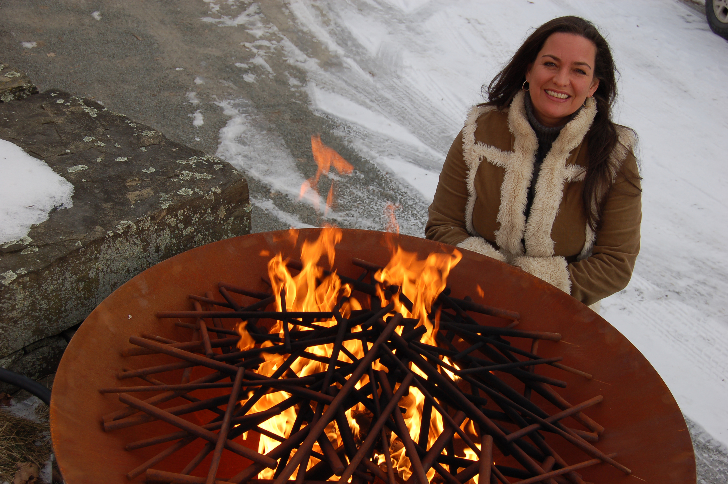 Elena Colombo takes off the winter chill. She’s pictured here with her corten steel firebowl with branch insert.