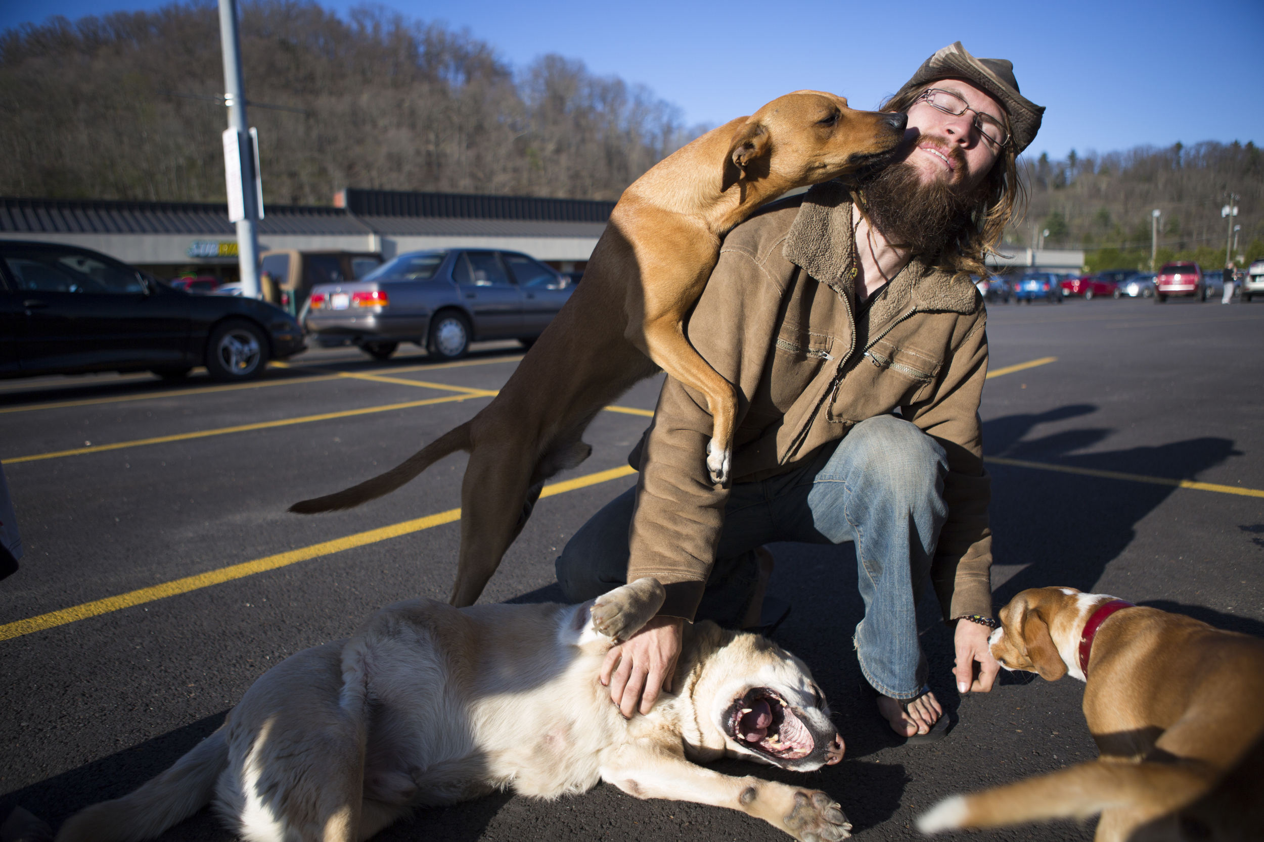  Amigo the dog licks Spiral's face as he returns to their van in a shopping center parking lot in Athens, Ohio. Spiral has permanent residence in California, but spends several months out of the year traveling to the east coast and then back to Calif