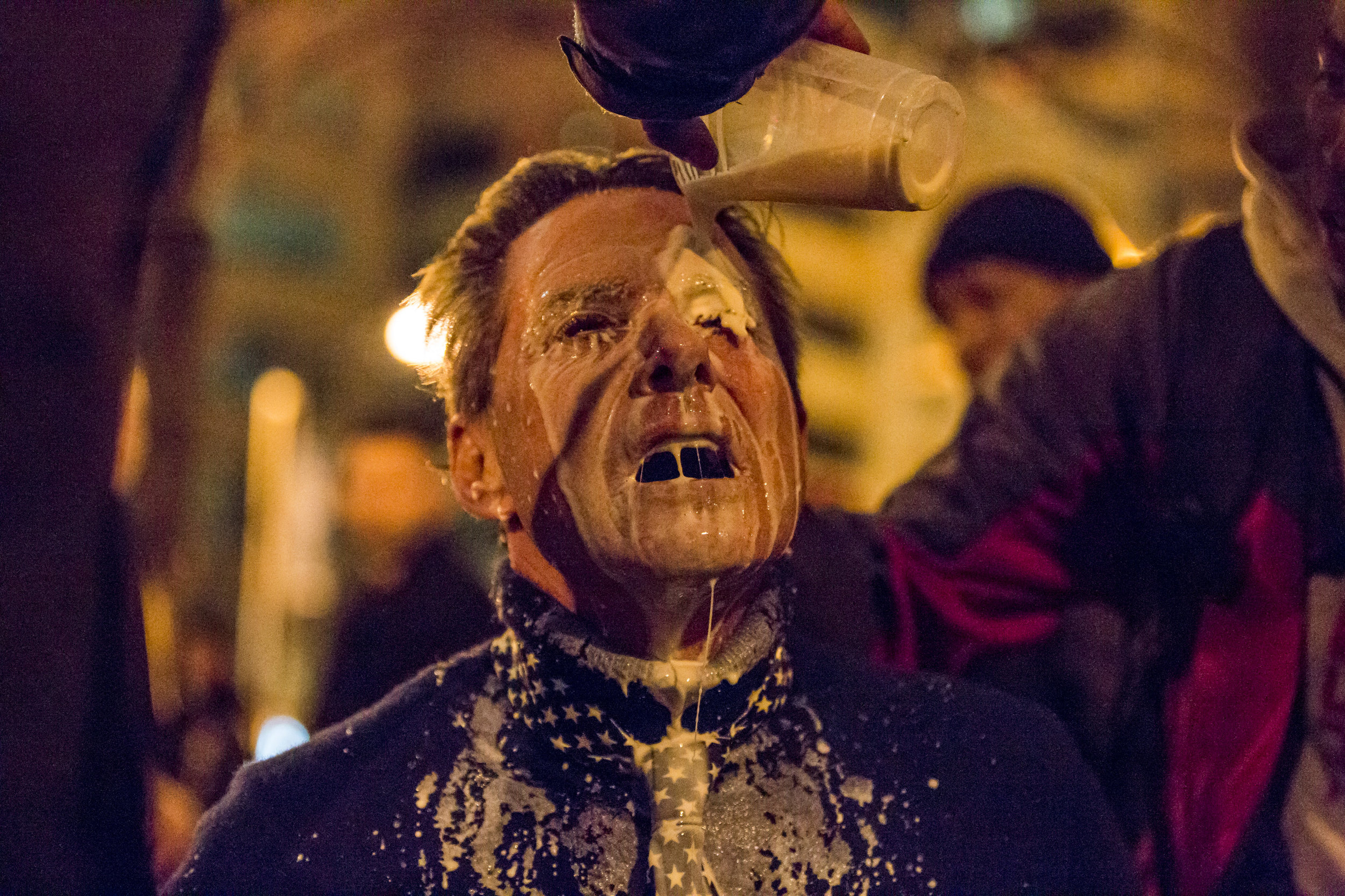  Protesters help pour milk into the eyes of Jeff Leonard, a Trump supporter from Las Vegas who was pepper sprayed. 