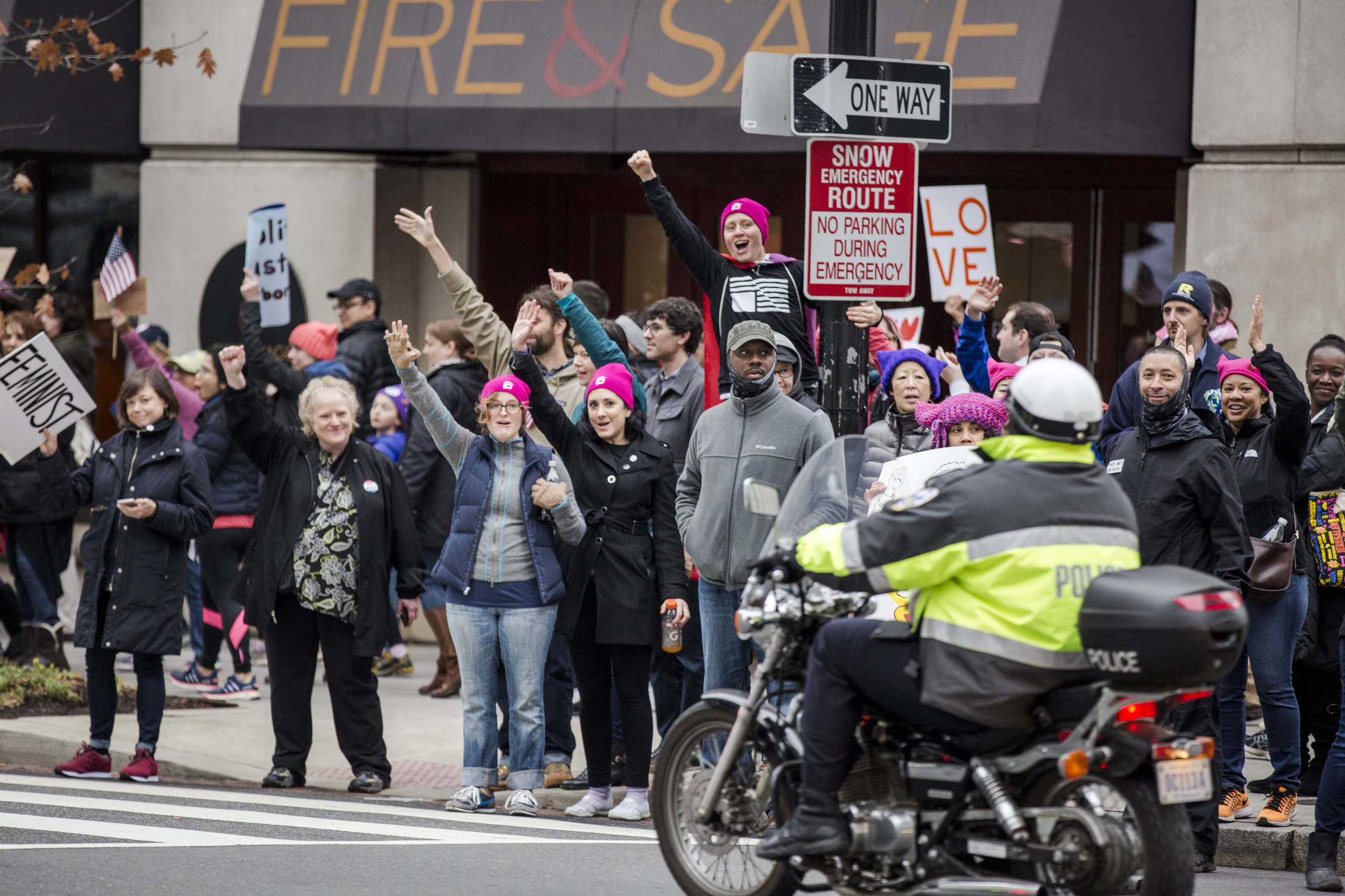  Women's marchers and police share a moment as the police honk and wave while passing. 