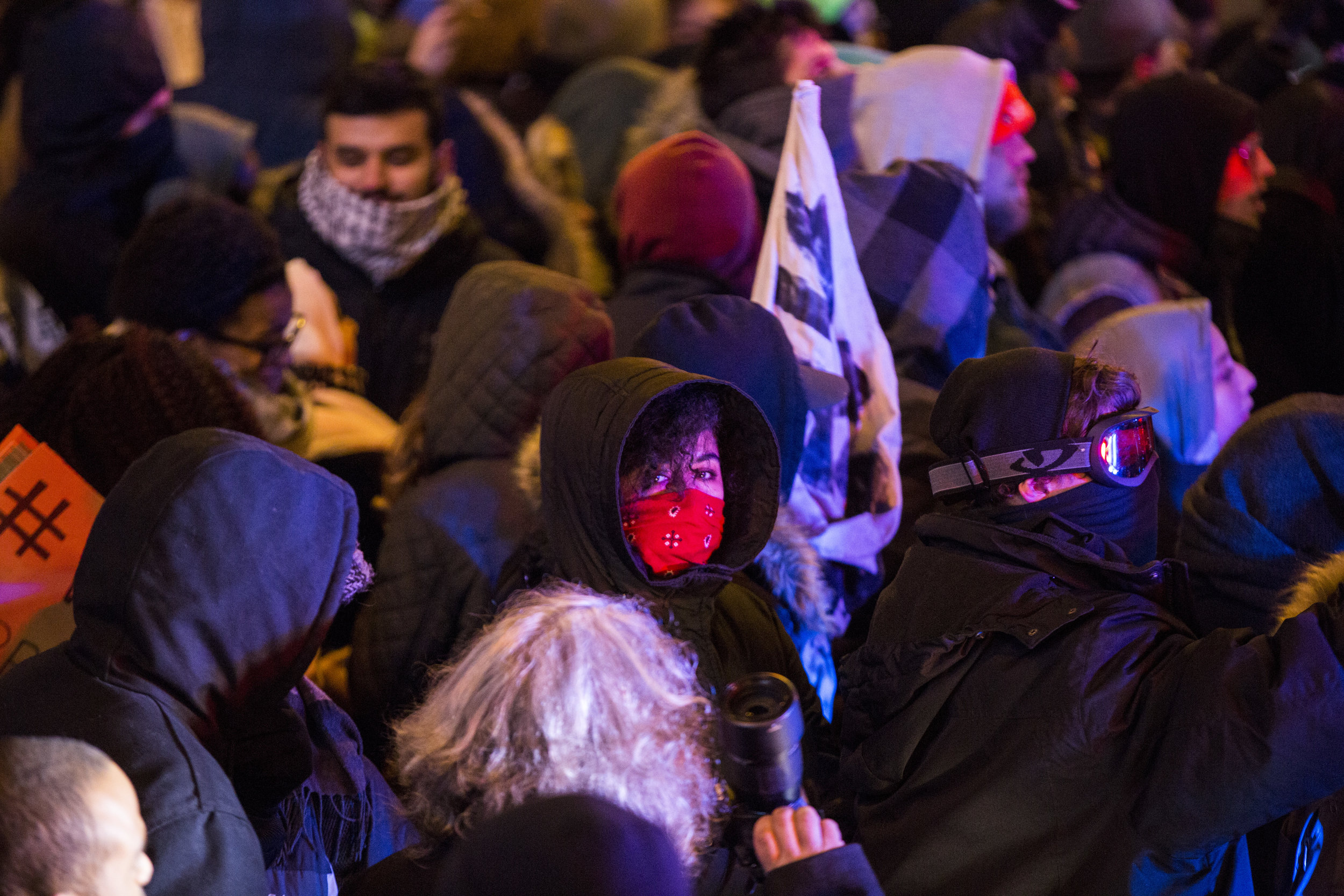 8:37 p.m. – Police supervisors are present, discussing with each other what to do. After many warnings to clear the area, protesters continue to chant, sing and raise peace signs, middle fingers or fists. Demonstrators begin to cover their mouths. Many are live streaming on Facebook or recording video. Officers begin to put on their gas masks at 8:45 p.m., according to the timestamps on my photos. Warnings continue from police.