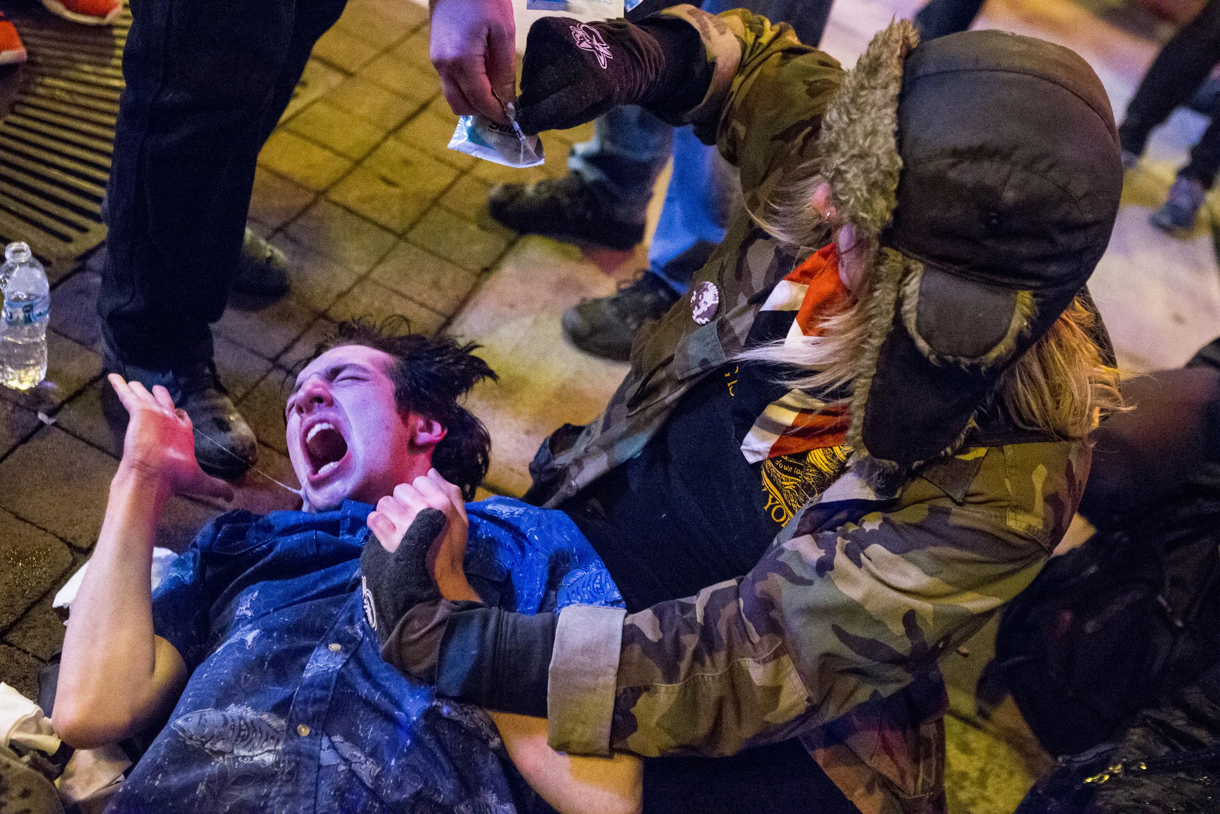 9:10 p.m. – “Medics” for the protesters help the peace sign guy, Connor Lefevers, who is obviously in pain. Actual medics, EMTs, are on the scene within about five minutes to assist victims of pepper spray. Everyone else disperses over time.
