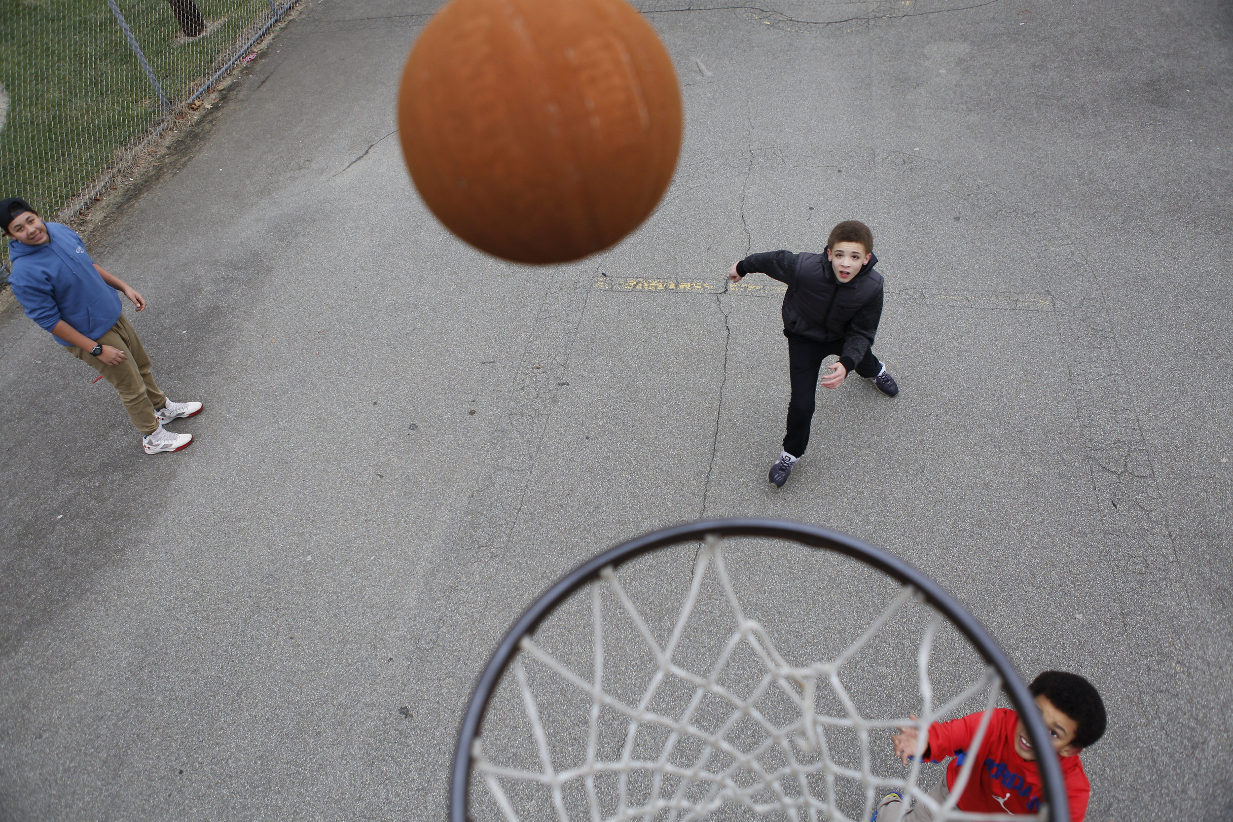  Teenagers play basketball on an unseasonably warm December day in Jeannette, Pennsylvania. 