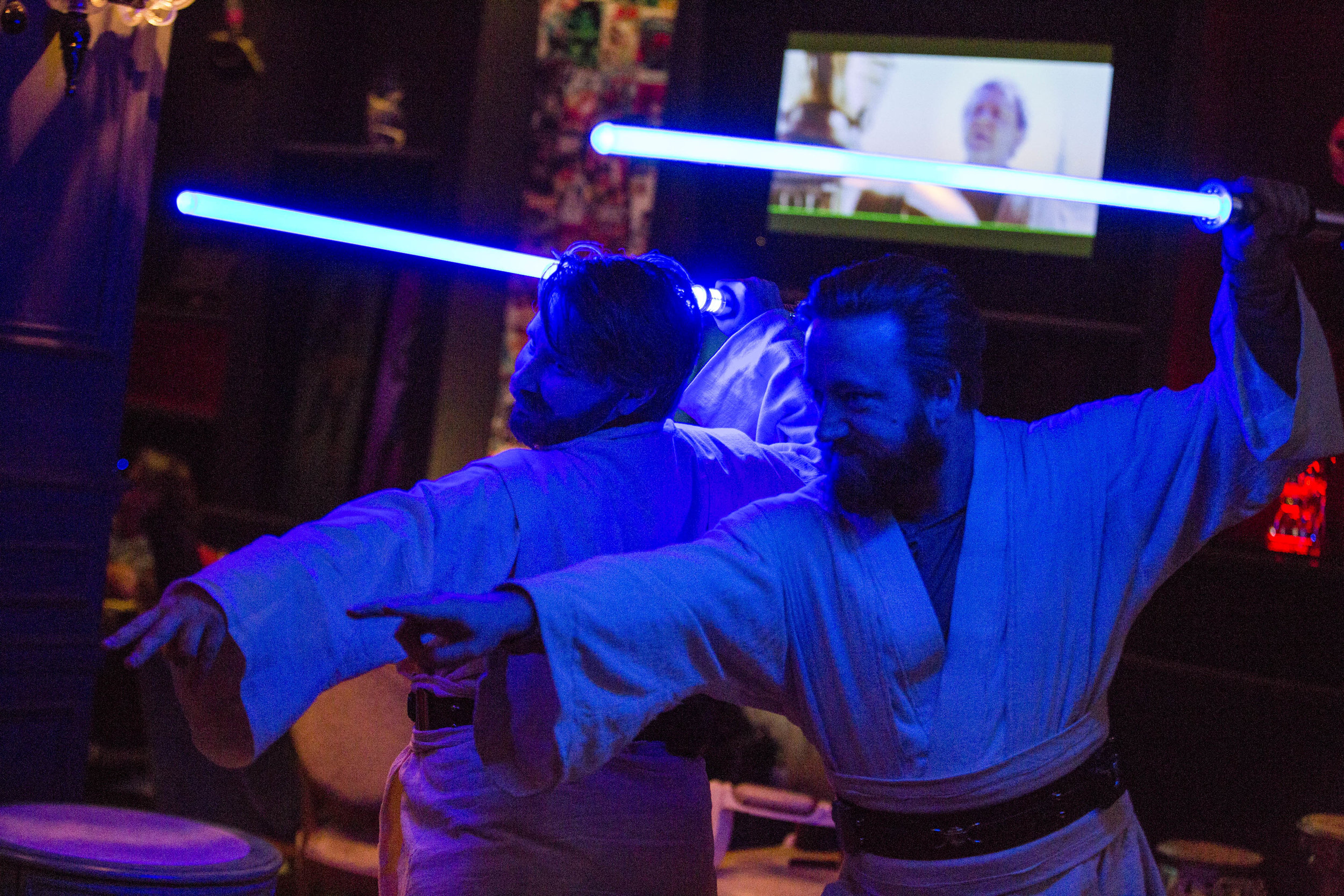 Rebecca Zobell, left, and Jack Stuart, both dressed as Obi Wan Kenobi, pose for their friends as they celebrate the 40th anniversary of the release of Episode IV – A New Hope at the Millennium Fandom Bar in the Arts District on Thursday, May 25, 201