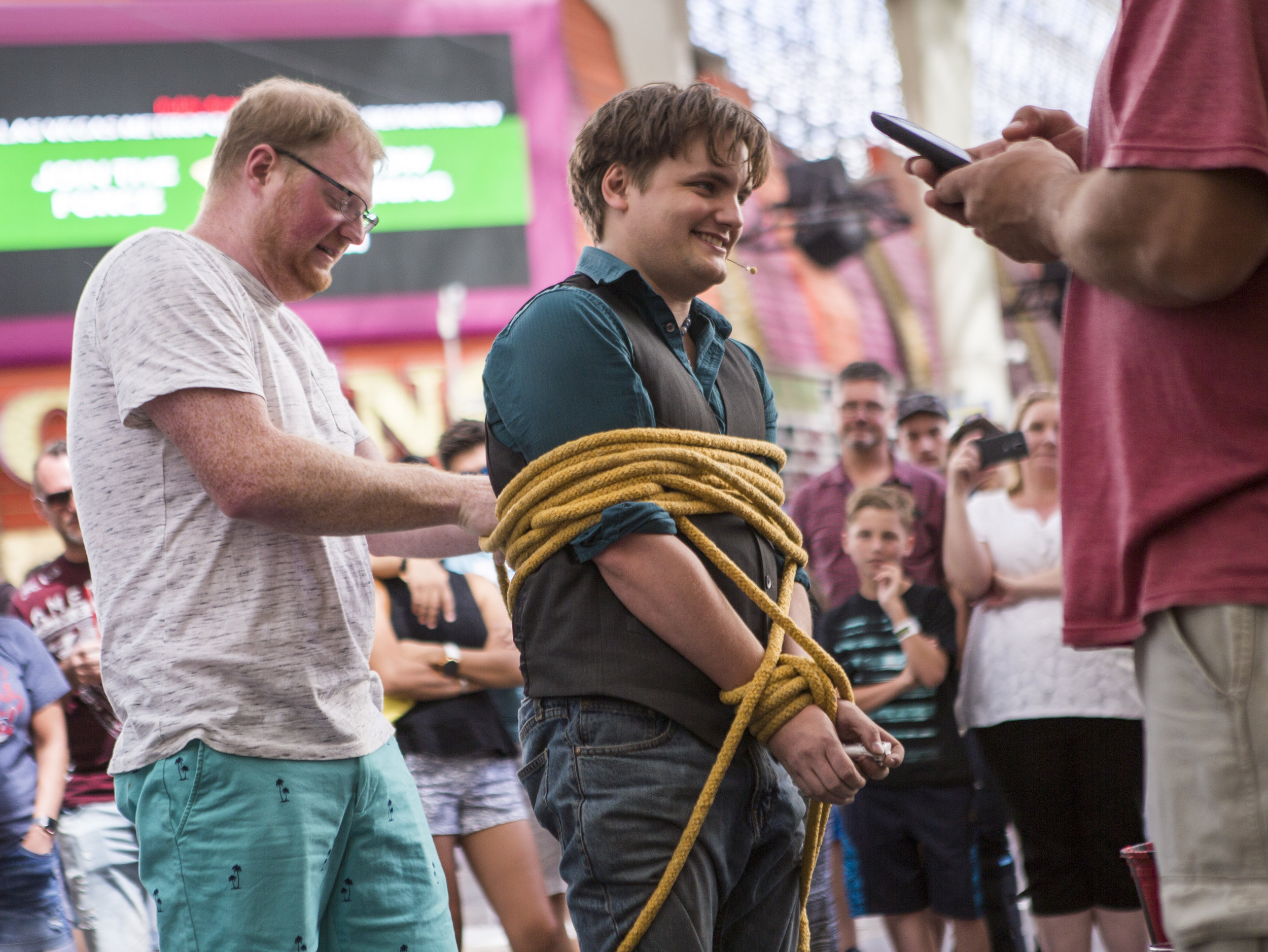  Jordan Lewis of Portland, Oregon, left, assists in tying up street magician Will Bradshaw on Fremont Street in Las Vegas on Tuesday, May 16, 2017. Bradshaw has lived in Las Vegas permanently for two years and performs anywhere between two and five d