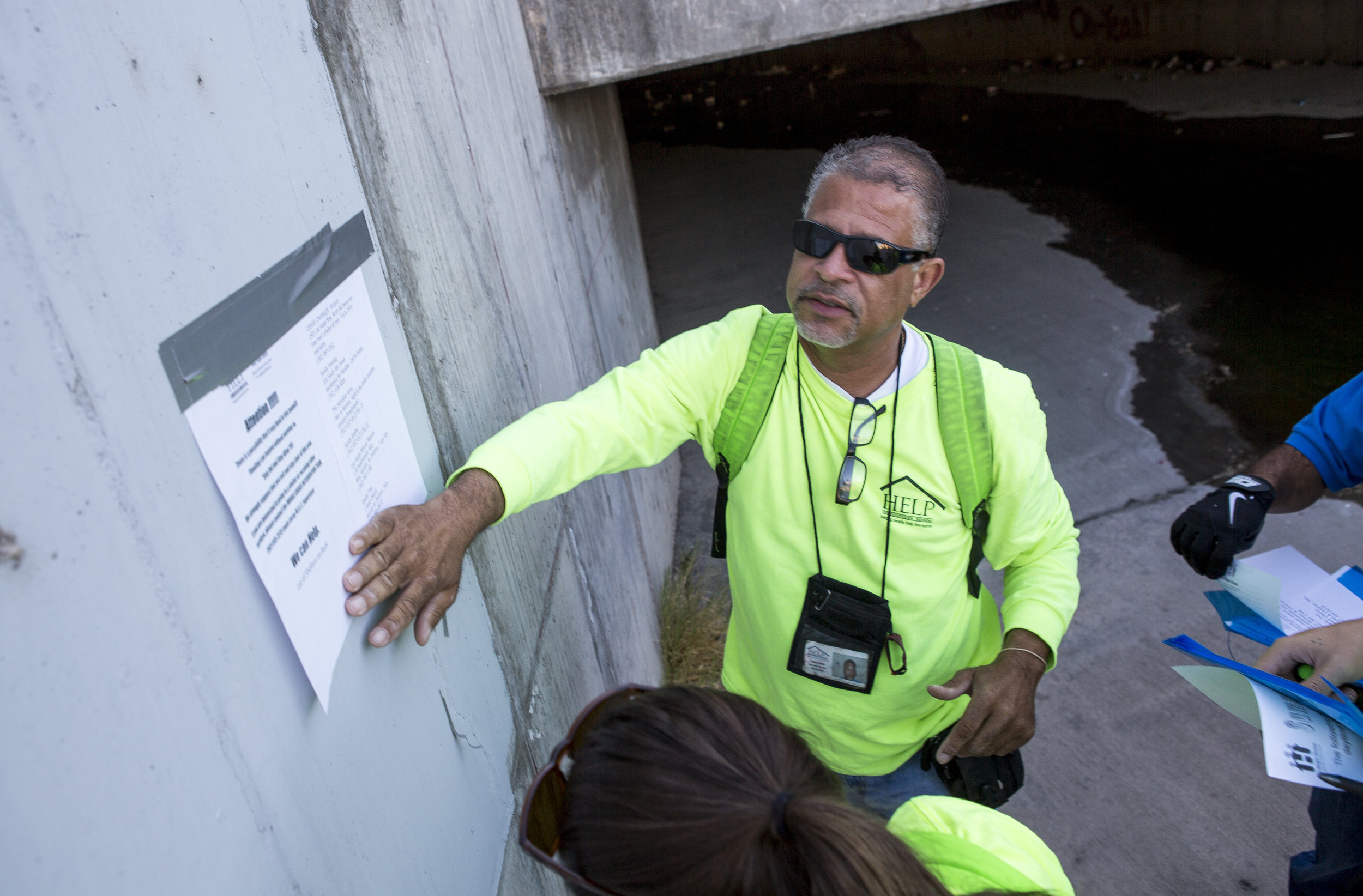  HELP of Southern Nevada employee Louis Lacey, the Mobile Crisis Intervention Team manager, puts up a sign warning the homeless about upcoming rain in monsoon season near flood tunnels under the Hard Rock Hotel and Casino on Tuesday, June 27, 2017.  