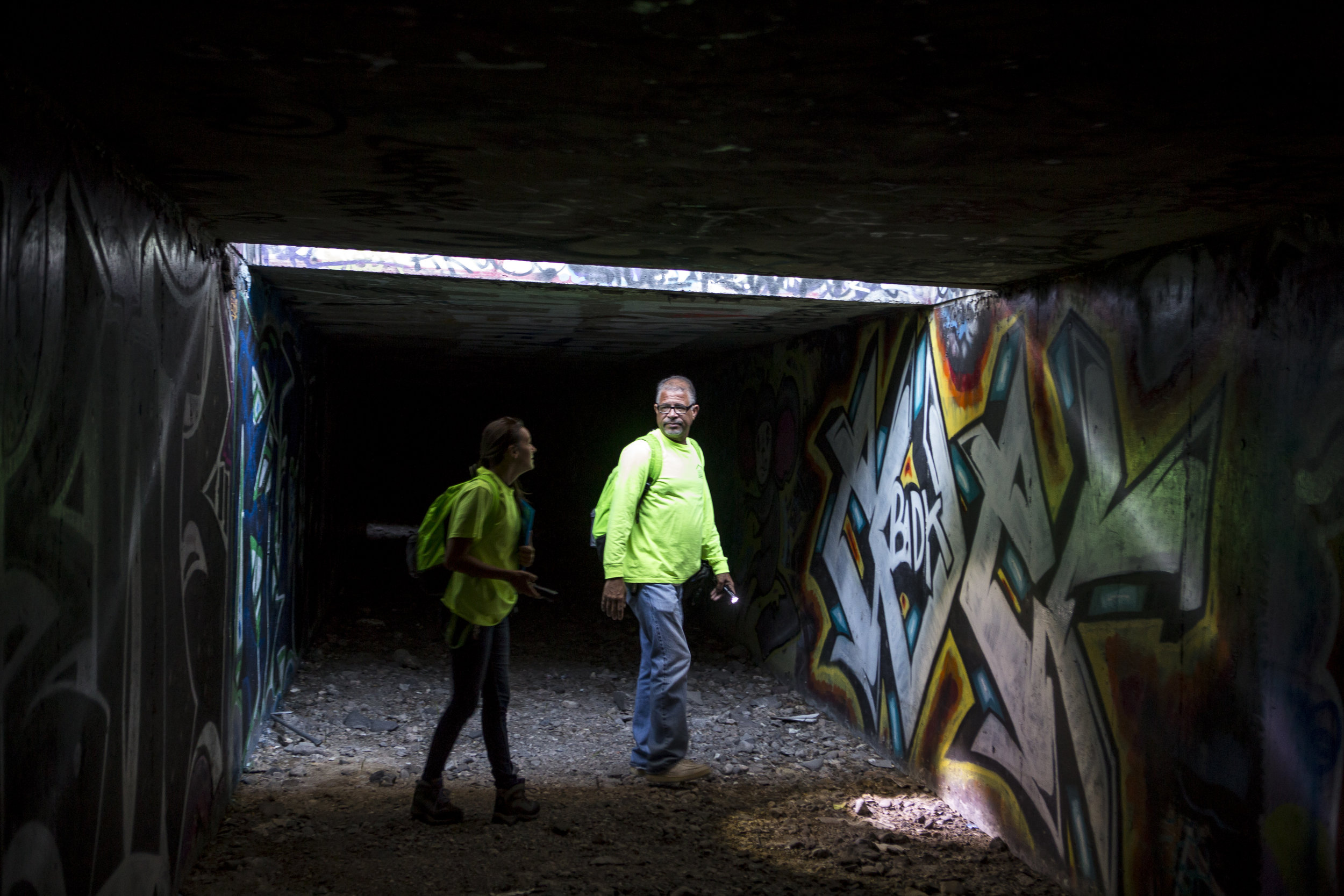  HELP of Southern Nevada employees Louis Lacey and Hayli Petcoff pause in a patch of light underneath Interstate 15 in a flood tunnel near the Hard Rock Hotel and Casino on Tuesday, June 27, 2017.  Patrick Connolly Las Vegas Review-Journal @PConnPie 