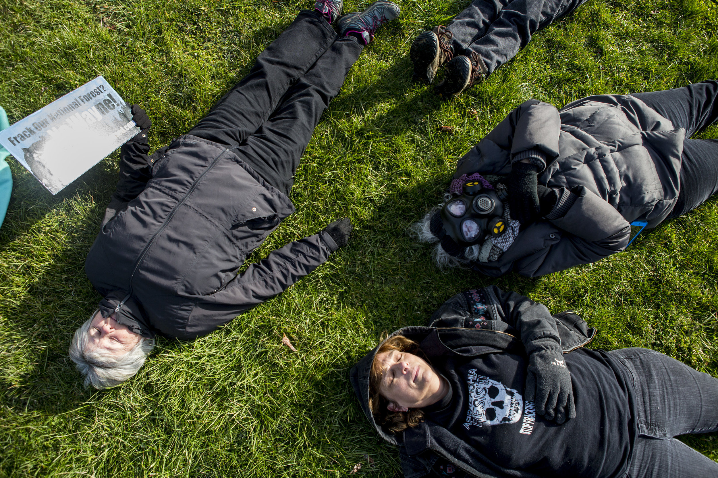  Protesters lay outside of the Wayne National Forest Headquarters during a "die-in" to demonstrate against the auction of Wayne land for fracking along Route 33 in Athens County, Ohio, on March 23, 2017. 