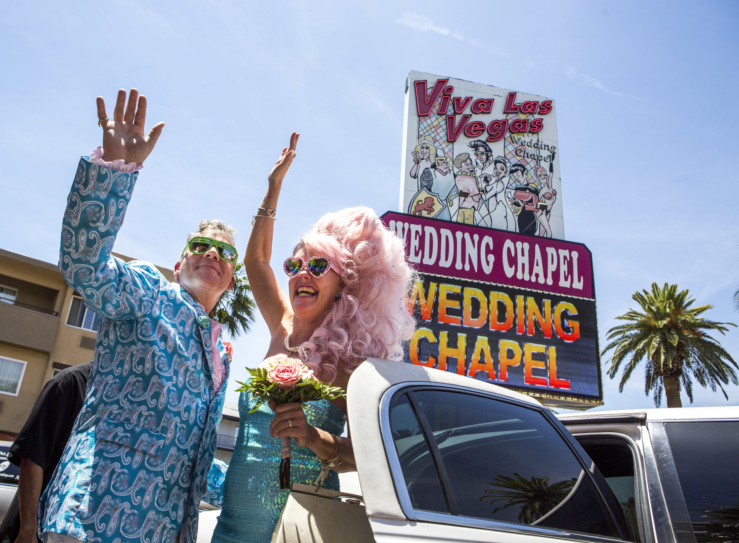  Andrea Cambridge and Chuck Varga wave goodbye to wedding guests after their Liberace-themed wedding at the Viva Las Vegas Wedding Chapel on Saturday, June 3, 2017. 