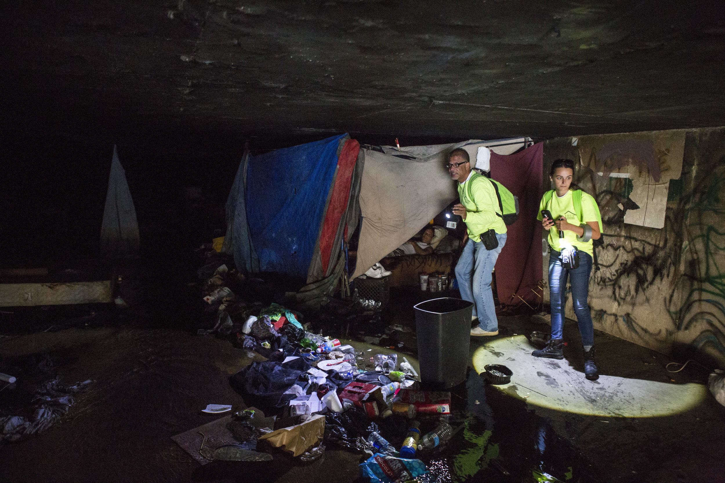  HELP of Southern Nevada employees Louis Lacey and Hayli Petcoff check on a homeless man in a flood tunnel near the Hard Rock Hotel and Casino on Tuesday, June 27, 2017. After two homeless people died in early monsoon rains the previous year, Lacey a