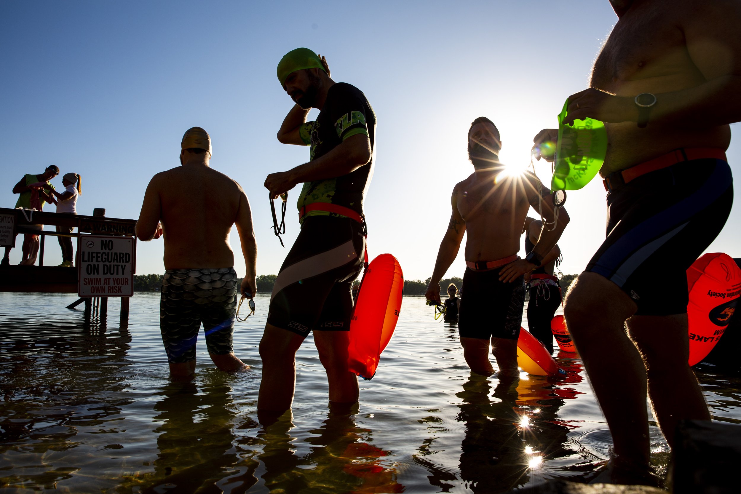  Swimmers enter the water of Lake Cane during the ninth annual Easter Eat, Pray, Swim event at Lucky's Lake Swim in Orlando. 