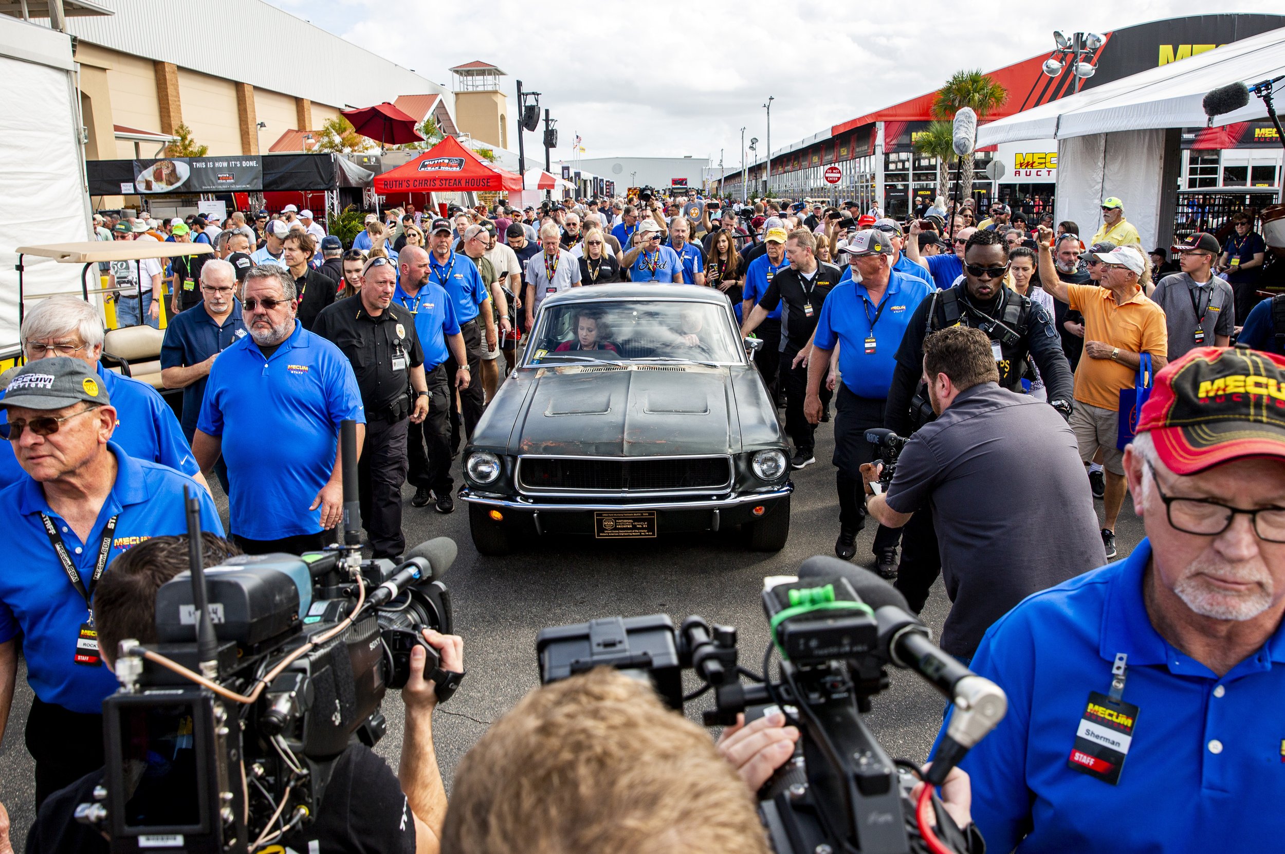  People surround the 1968 "Bullitt" Mustang GT car, Friday, Jan 10, 2020, in Kissimmee, Fla. The iconic Highland Green 1968 Mustang GT that once made history for its appearance in the film “Bullitt” is now making history again. It fetched $3.74 milli