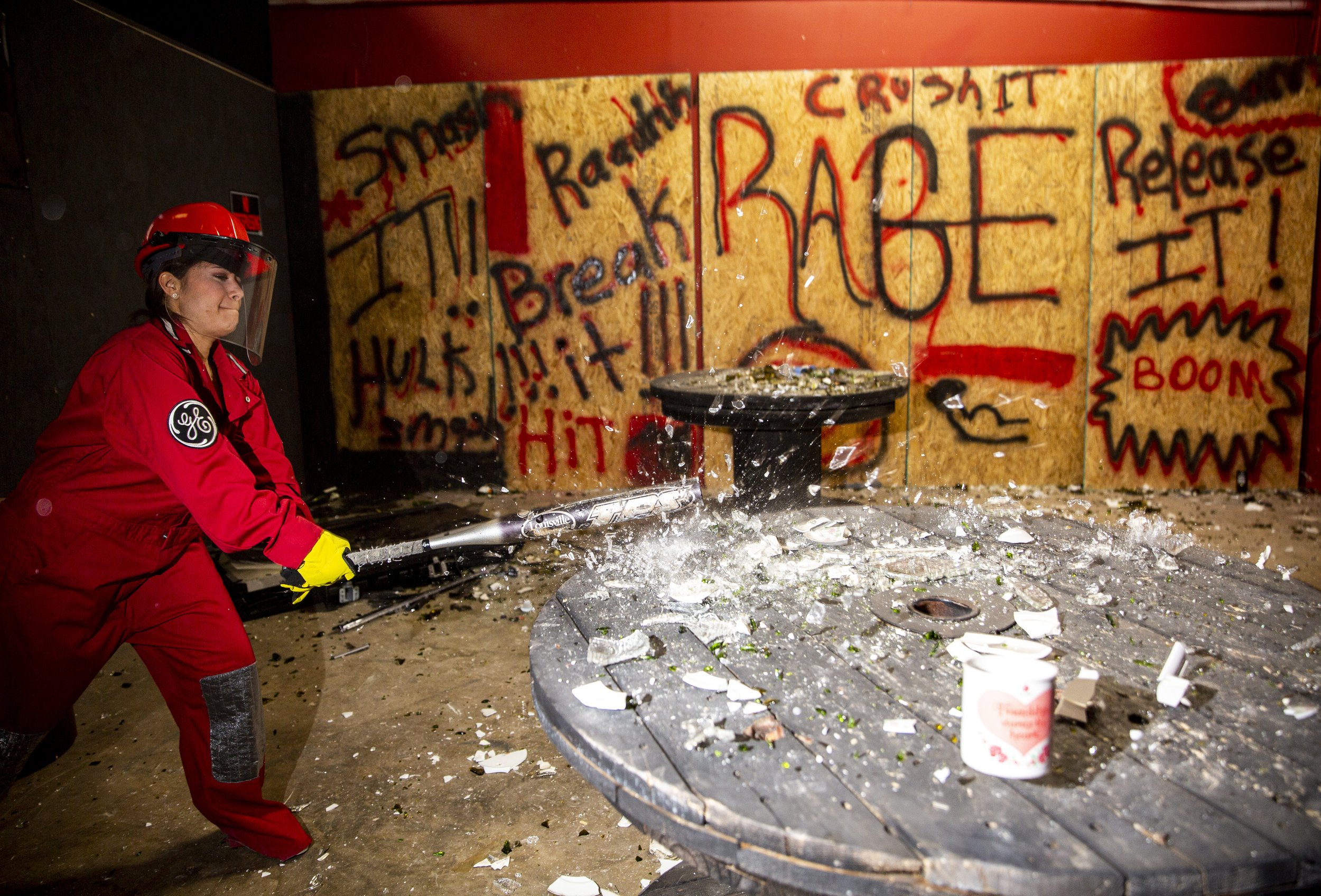  Tabitha Adorno smashes glassware at the Anger Management Rage Room in Orlando on Friday, May 22, 2020.  