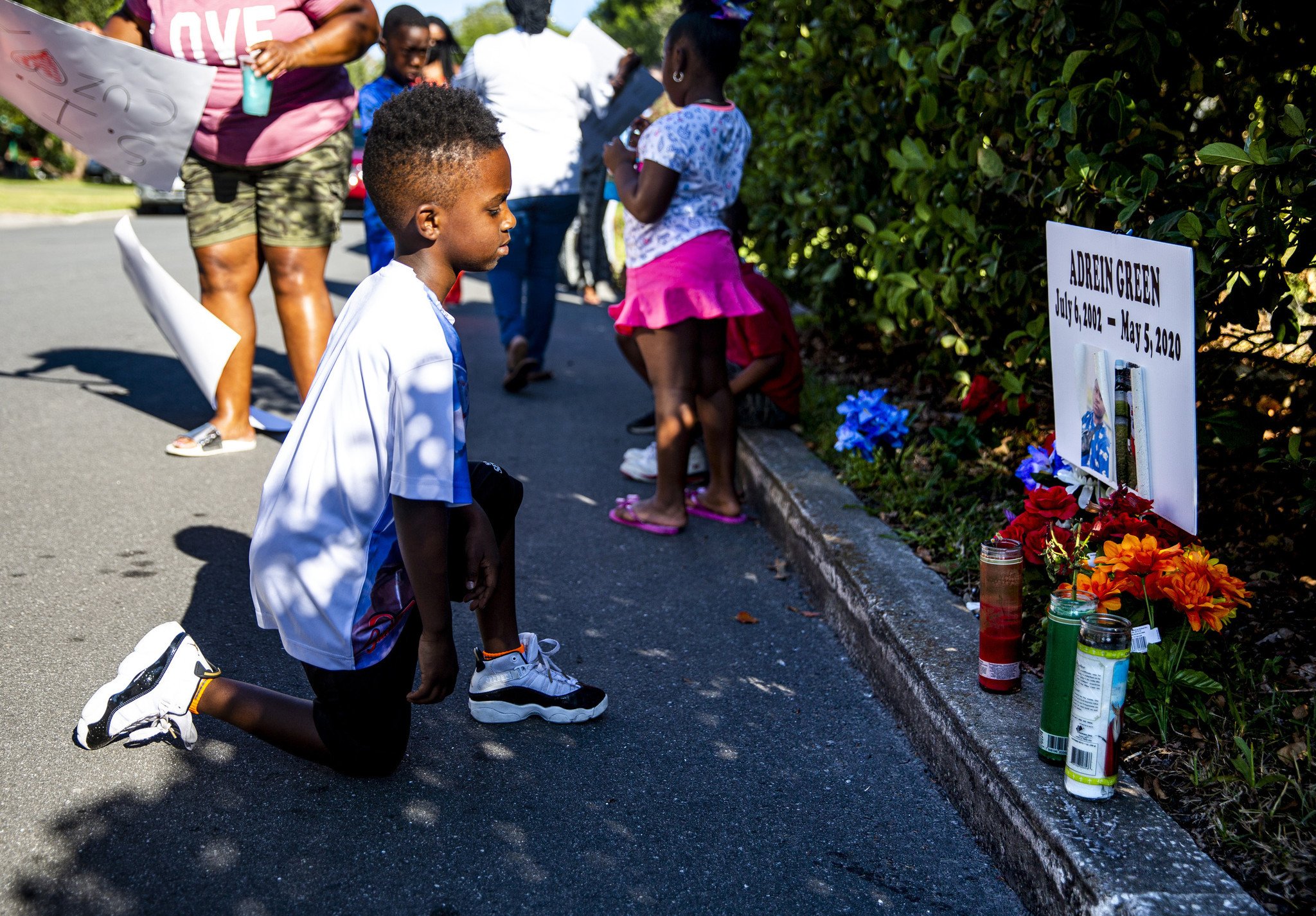  Eylijah Campbell, 6, looks at the memorial for his cousin, Adrein Green, during a vigil at the location where the 17-year-old was shot on Anderson Circle in Sanford on Tuesday, May 19, 2020. The Sanford teenager was shot and killed by a homeowner du