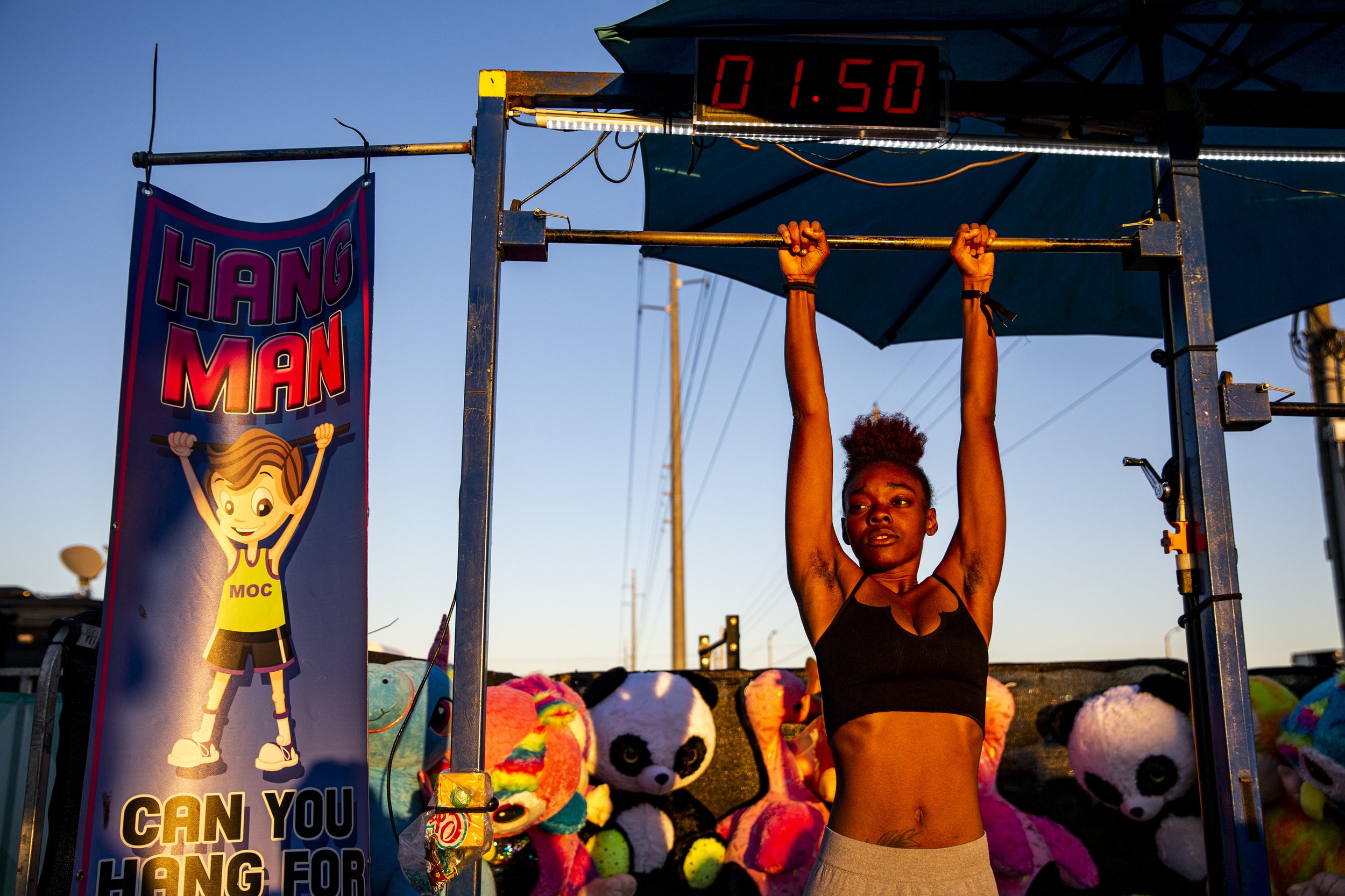  Orlando resident Quiana Holmes tries to hang from the bar for two minutes at the Central Florida Fair on Thursday, Feb 27, 2020. 