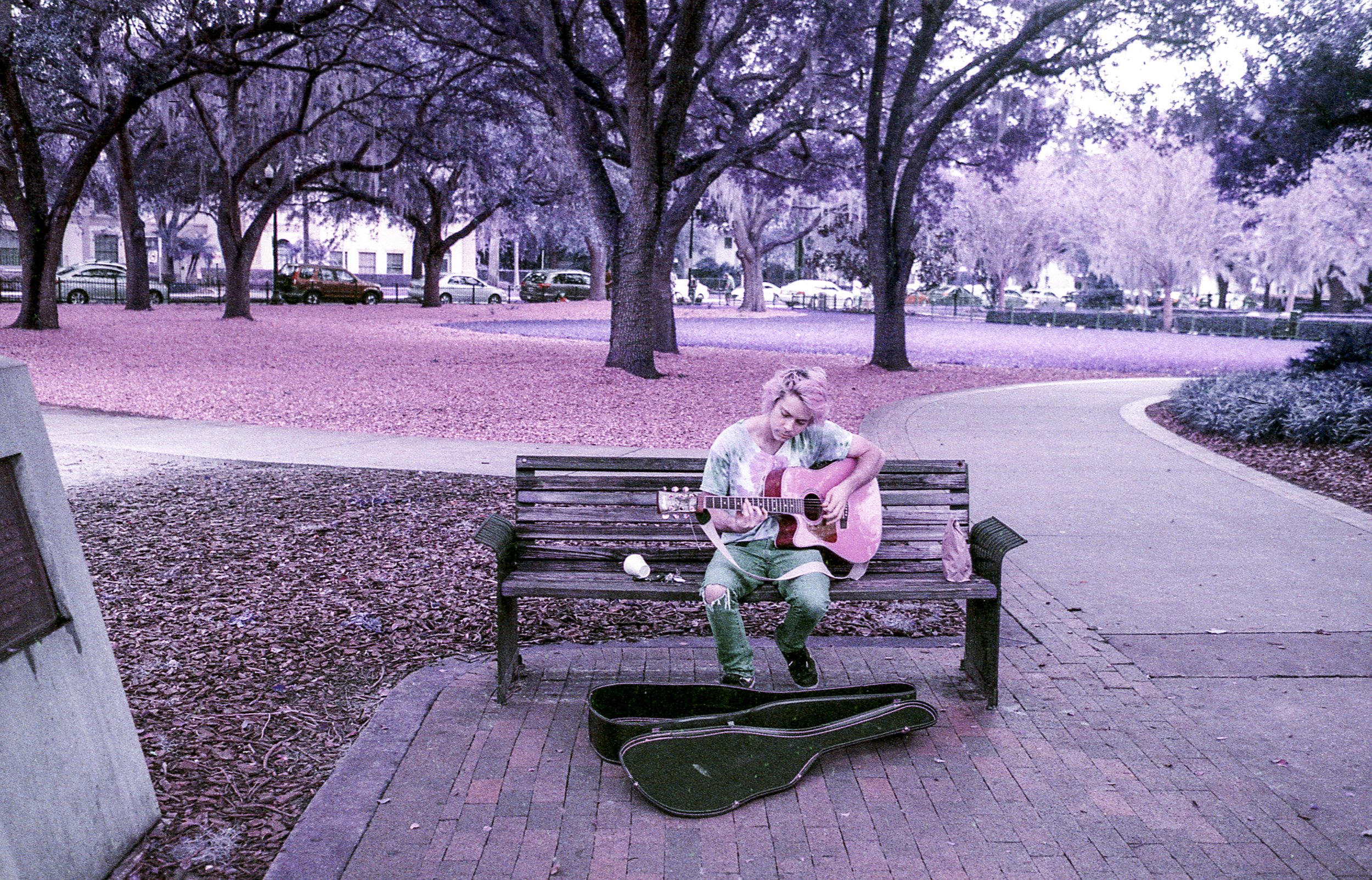  A busker plays guitar at Lake Eola Park in Orlando, shot on Lomography Purple film. 