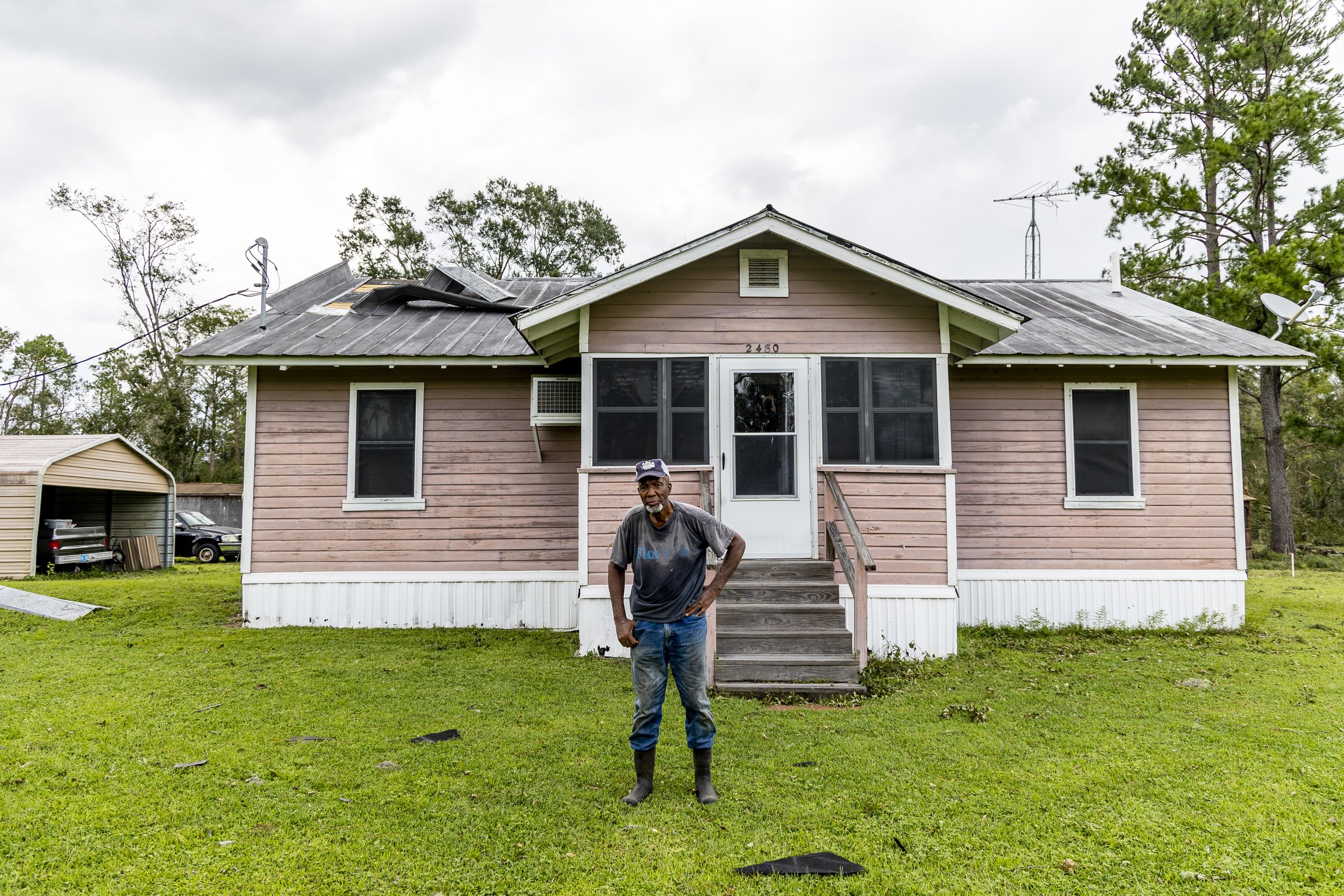  Deacon Freddie Richet stands outside the 1950s home that once belonged to his parents in Taylor County on Thursday, Aug. 31, 2023. The county felt the full impacts of Hurricane Idalia, which made landfall near Category 4 strength on Wednesday mornin