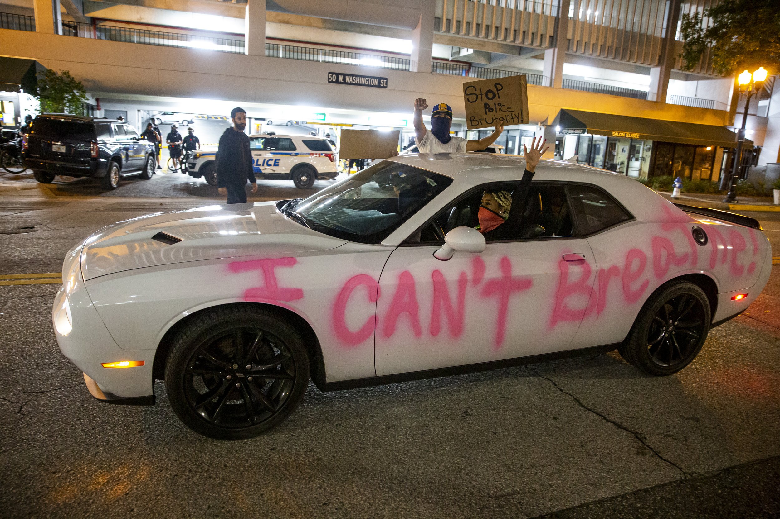  A car passes by with "I can't breathe" painted on the side during a demonstration demanding justice for George Floyd in Orlando on Sunday, May 31, 2020. 