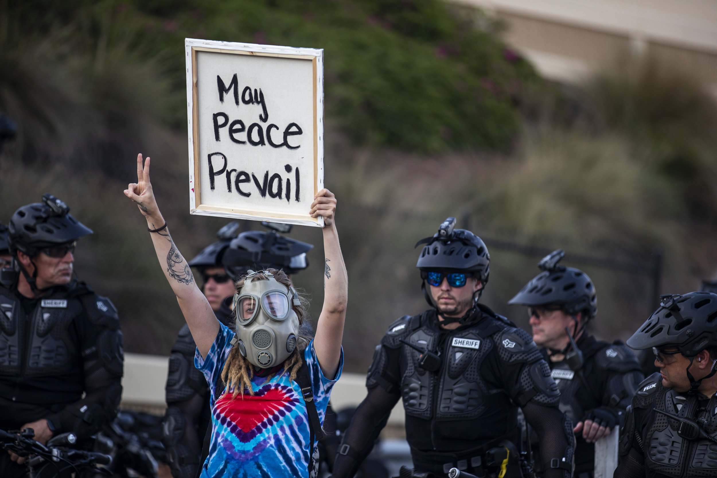  Police block an on ramp to State Road 408 while a protester holds up a sign during a demonstration demanding justice for George Floyd in Orlando on Sunday, May 31, 2020. 