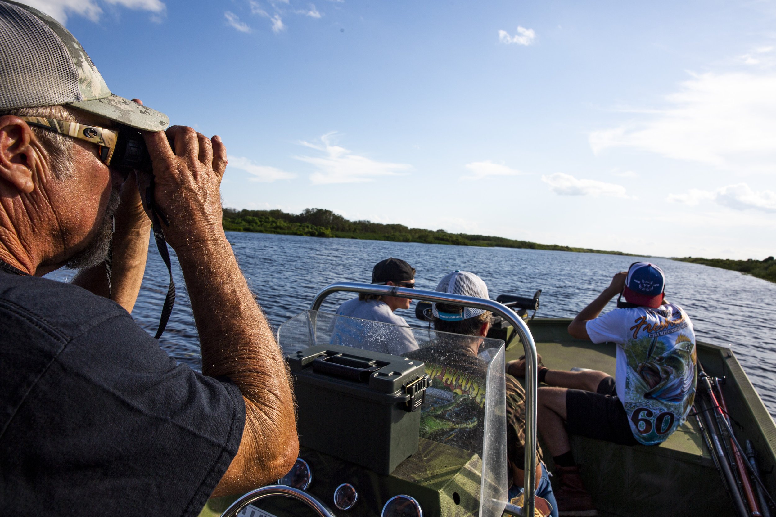  Capt. Bob Stafford looks out of binoculars to spot gators during an alligator hunt with Okeechobee Charters on Lake Okeechobee Friday, Sept. 27, 2019. Alligators were hunted to near extinction in Florida before they became protected in the 1960s, ca