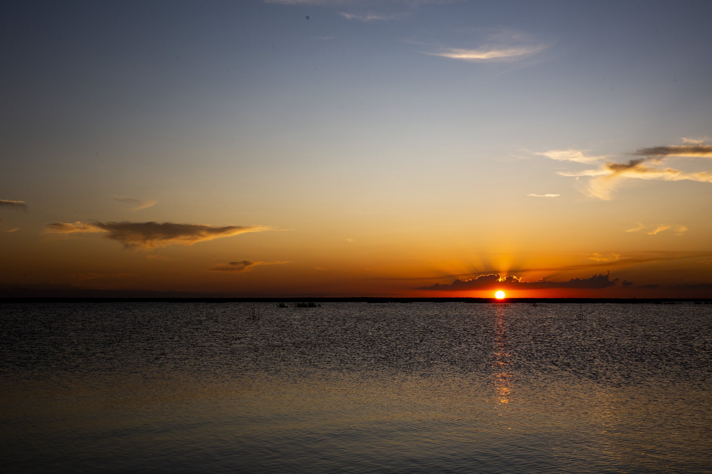  The sun sets on Lake Okeechobee during an alligator hunt with Okeechobee Charters on Friday, Sept. 27, 2019. 