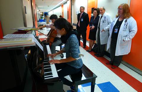 Performance in the hospital wing hallway with cellist, Mitchell Lyon, as part of the Gluck Community Service Fellowship