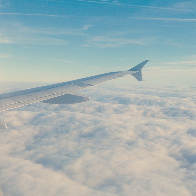 Flying into Dublin. The sun just hides just above the clouds.