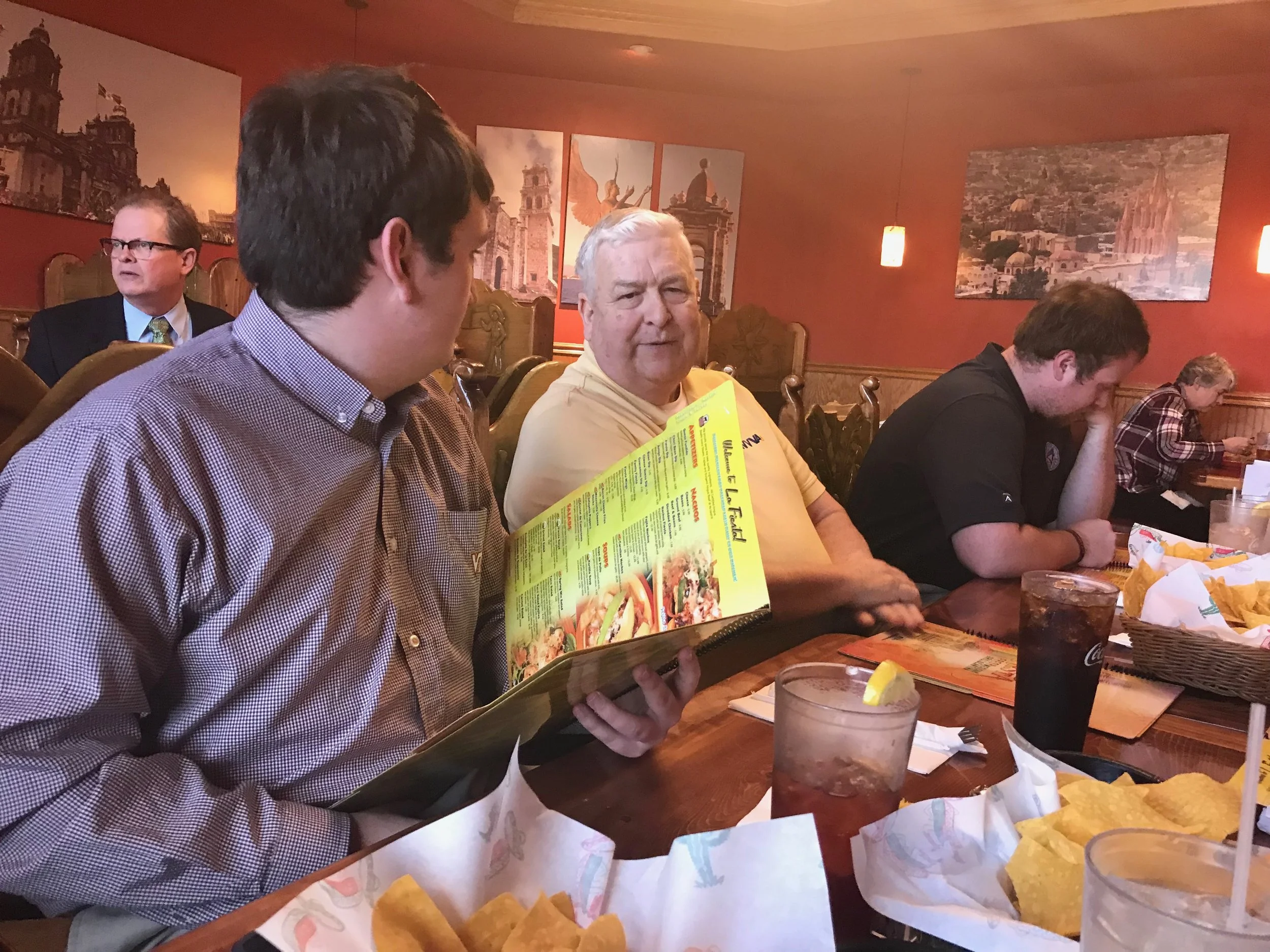 Virginia Tech journalist Trey Lyle visits with WVVA-TV Vice-President and General Manager Frank Brady at lunch following the group's recent visit to the Bluefield television station.