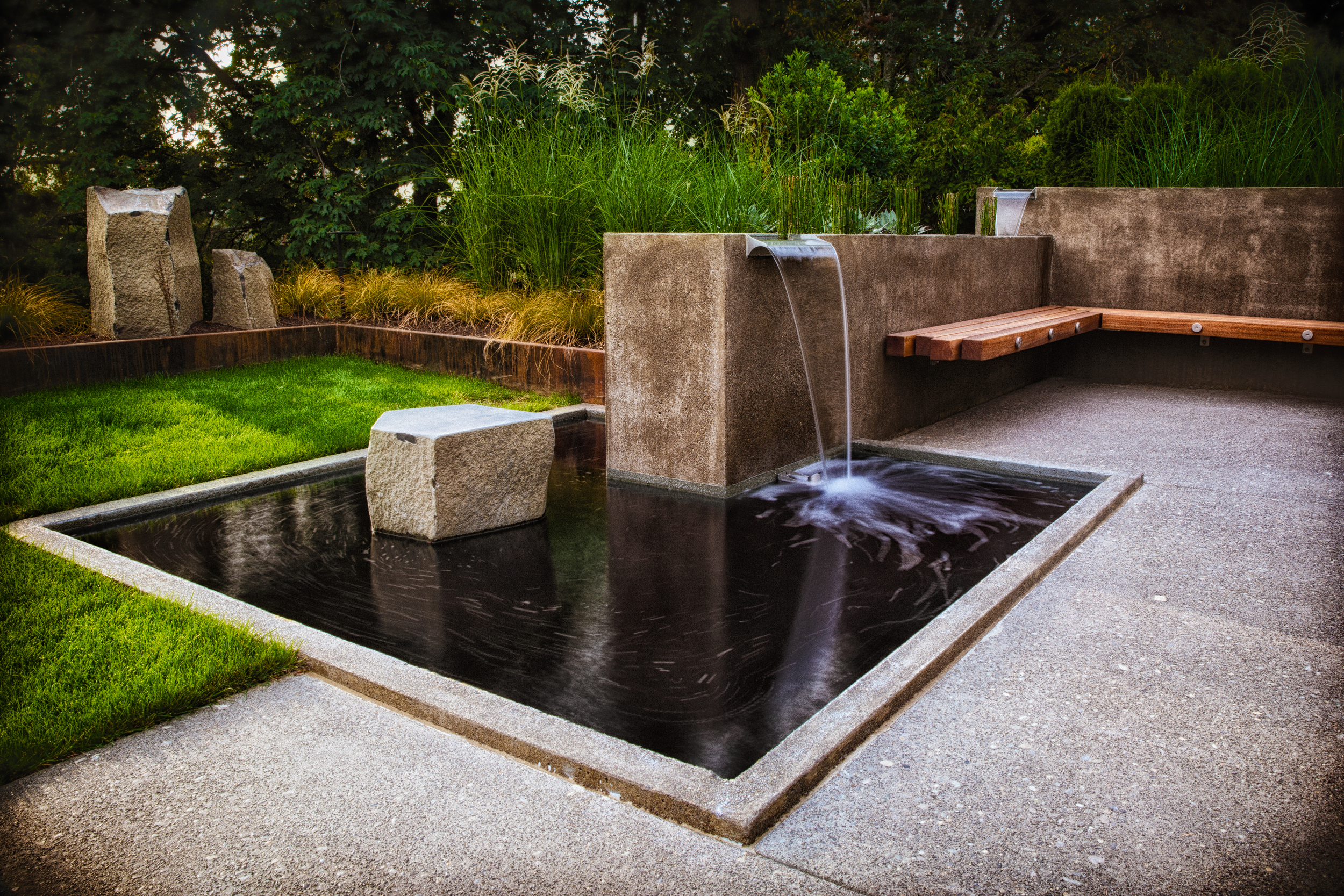 Concrete Water Feature with Spillways, River Rock and Reeds, Batu Bench, and Basalt Boulder