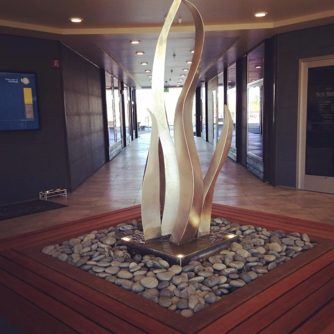 Stainless Sculpture with Batu Bench and Sealed Pebble