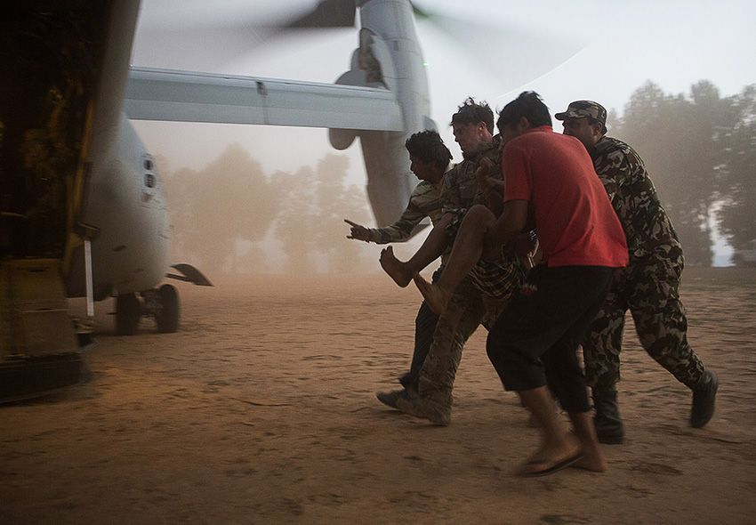 1st place in the Combat Operations category: A U.S. Air Force pararescueman with Joint Task Force 505 helps evacuate earthquake victims from an area near Charikot, Nepal, after a 7.3 magnitude earthquake struck the country, May 12. JTF 505 along with other multinational forces and humanitarian relief organizations are currently in Nepal providing aid after a 7.8 magnitude earthquake struck the country on April 25. At Nepal’s request, the U.S. government ordered JTF 505 to provide unique capabilities to assist Nepal. IMAGE: STAFF SGT. JEFFREY D. ANDERSON, USMC