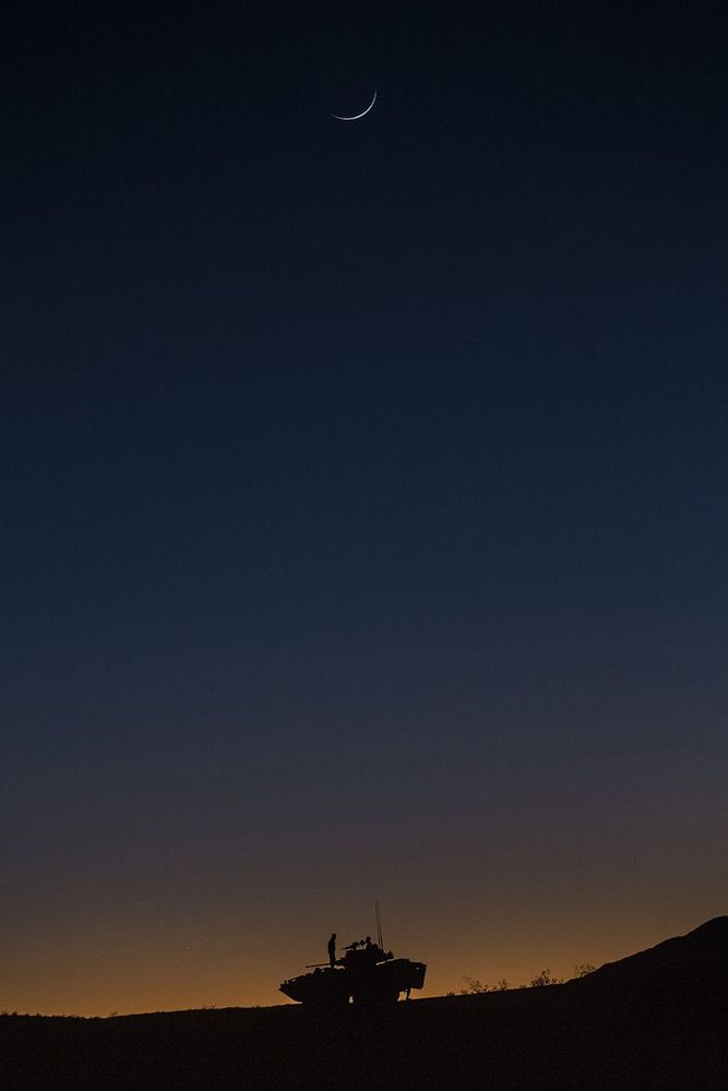 1st place in the Pictorial category: A U.S. Marine with Bravo Company, 1st Light Armored Reconnaissance Battalion, 1st Marine Division, stands on top of a Light Armored Vehicle 25 during duck for Steel Knight 16 (SK-16), at National Training Center Fort Irwin, Calif., Dec. 13, 2015. Steel Knight is an annual field training exercise that enables 1st Marine Division to test and refine its command and control capabilities by acting as the command element for a forward-deployed Marine Expeditionary Force. IMAGE: CPL. MATTHEW HOWE, USMC